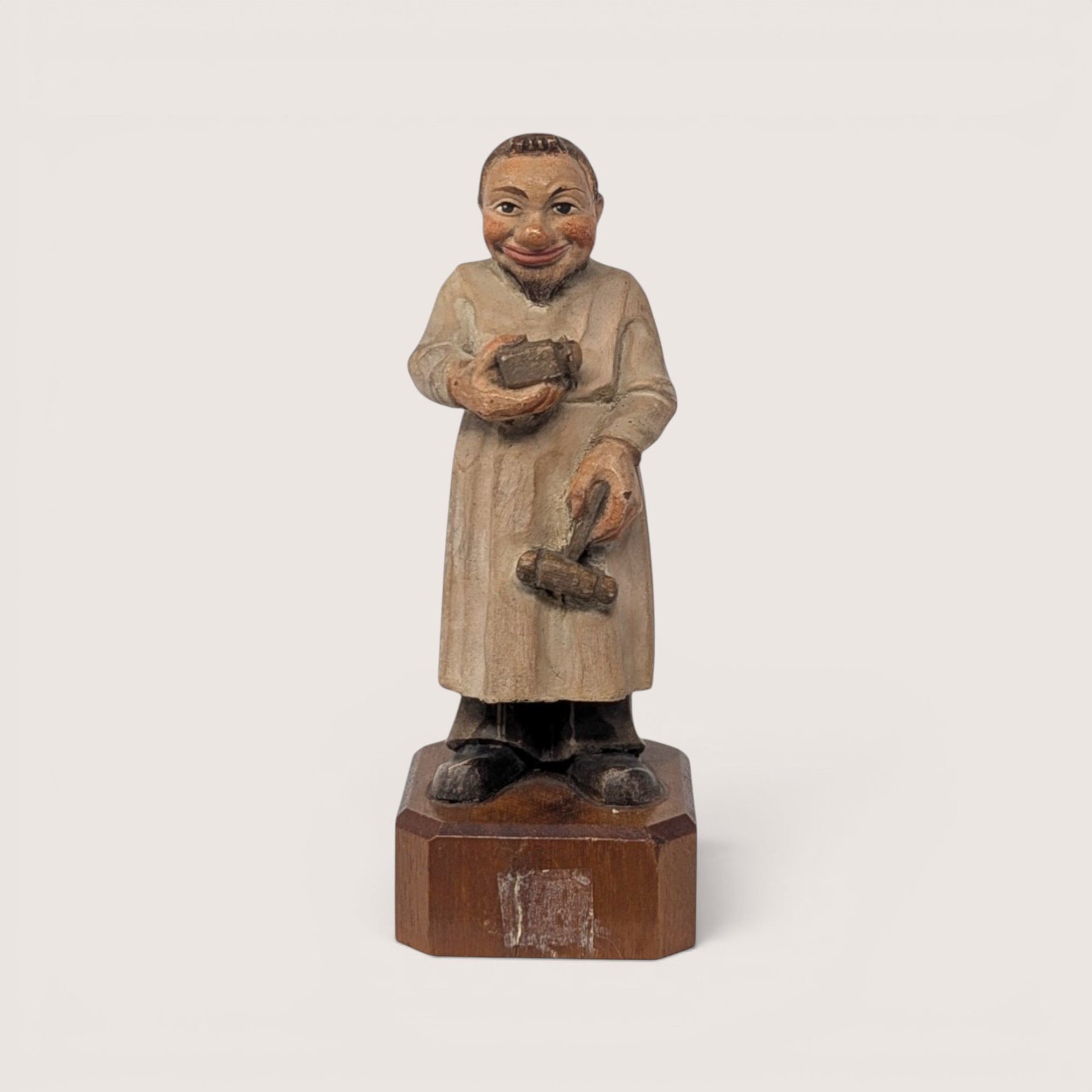 Vintage Anri Toriart hand-carved wood figurine of an old-world apothecary pharmacist holding a mortar and pestle.