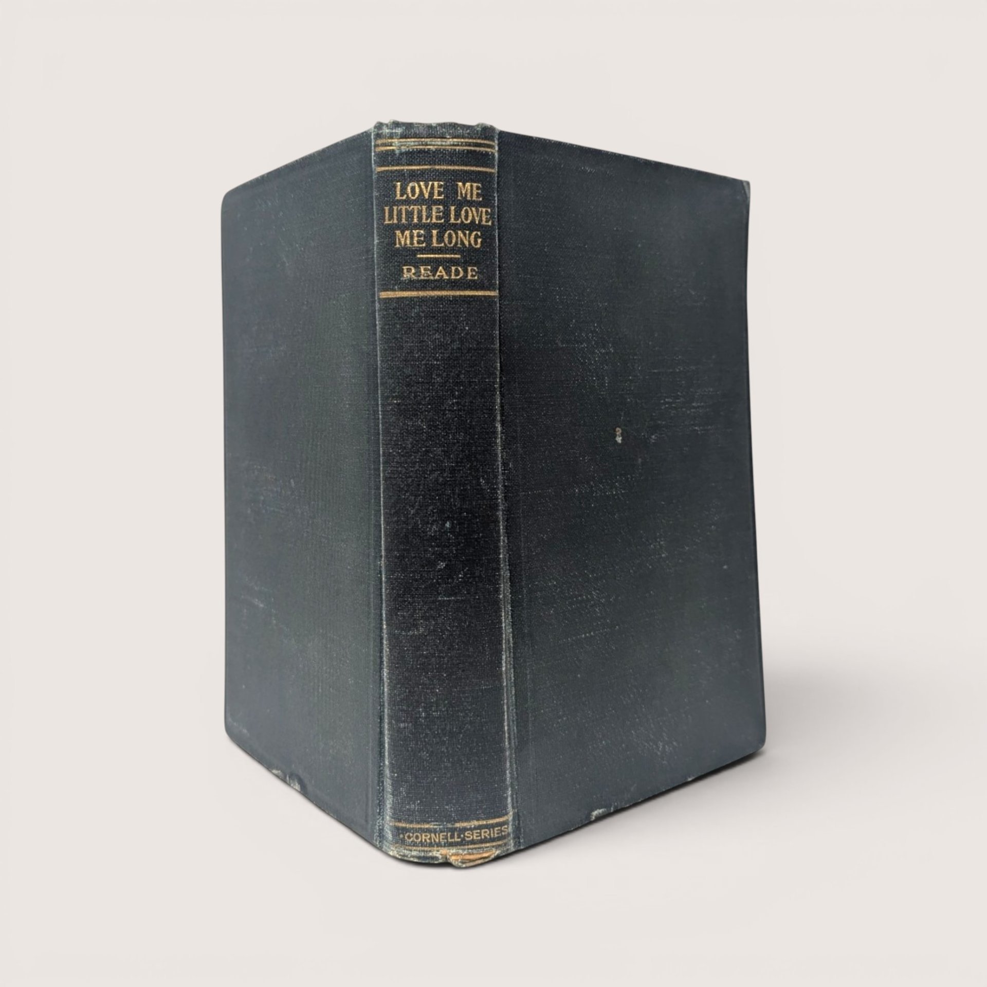 Vintage hardcover book titled Love Me Little, Love Me Long by Charles Reade with a dark clothbound spine.