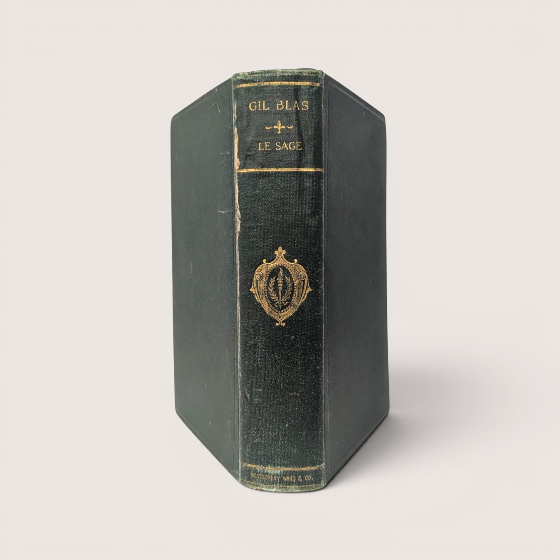 Vintage Montgomery Ward hardcover book The Adventures of Gil Blas by Le Sage with green cover and illustration.