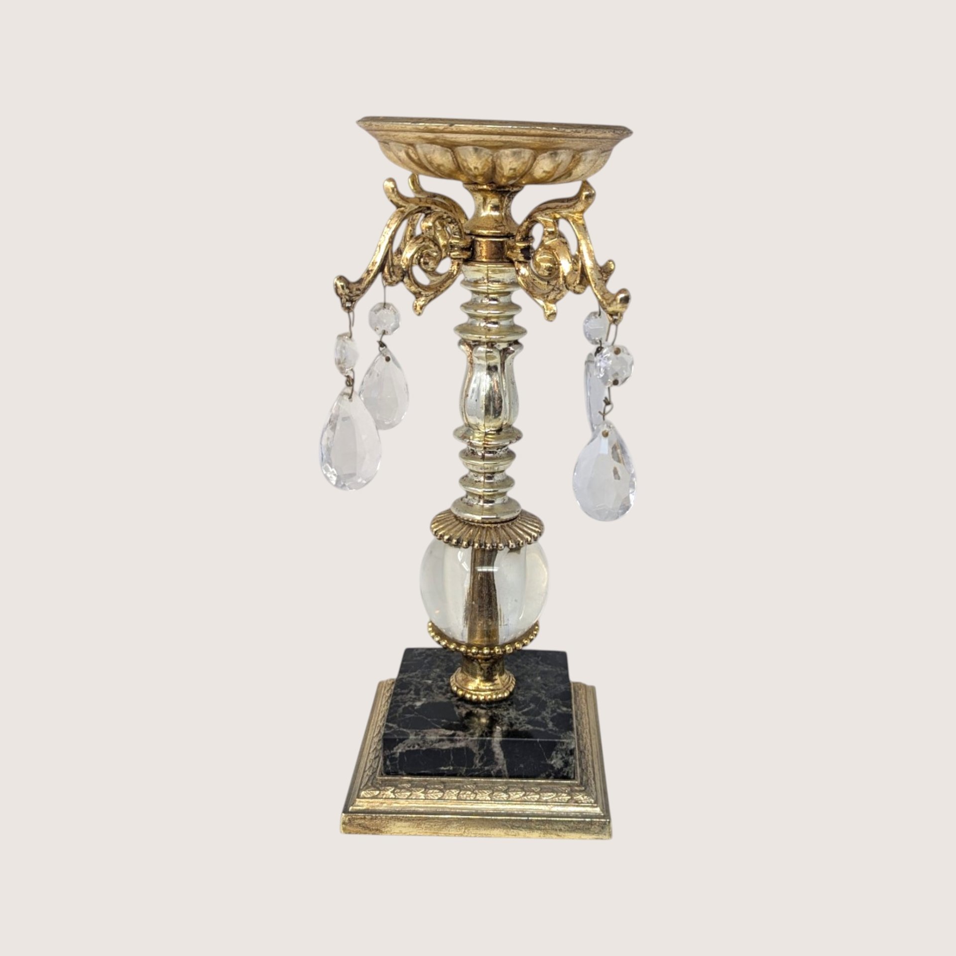 Vintage ornate brass colored metal and crystal candlestick holder with black marble base and hanging prisms.