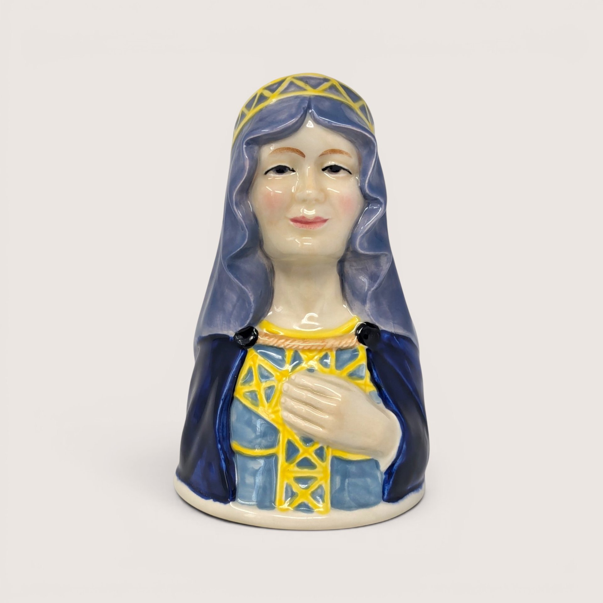 Vintage 1983 Royal Cornwall Maid Marian ceramic character bell in blue and yellow glaze.