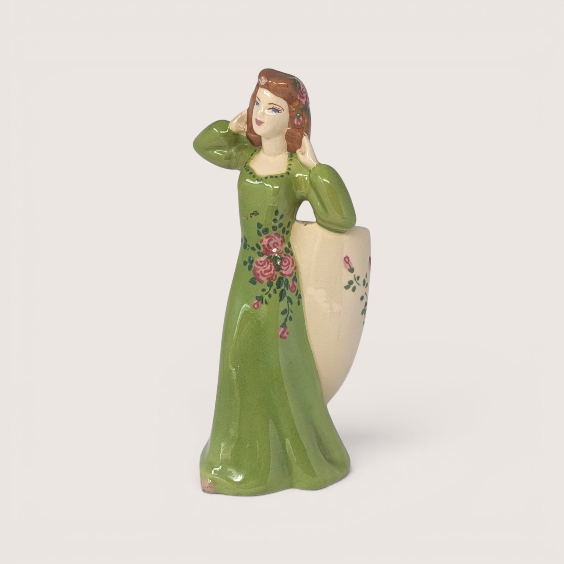 Vintage ceramic lady head vase and figurine in a green dress holding a floral planter.