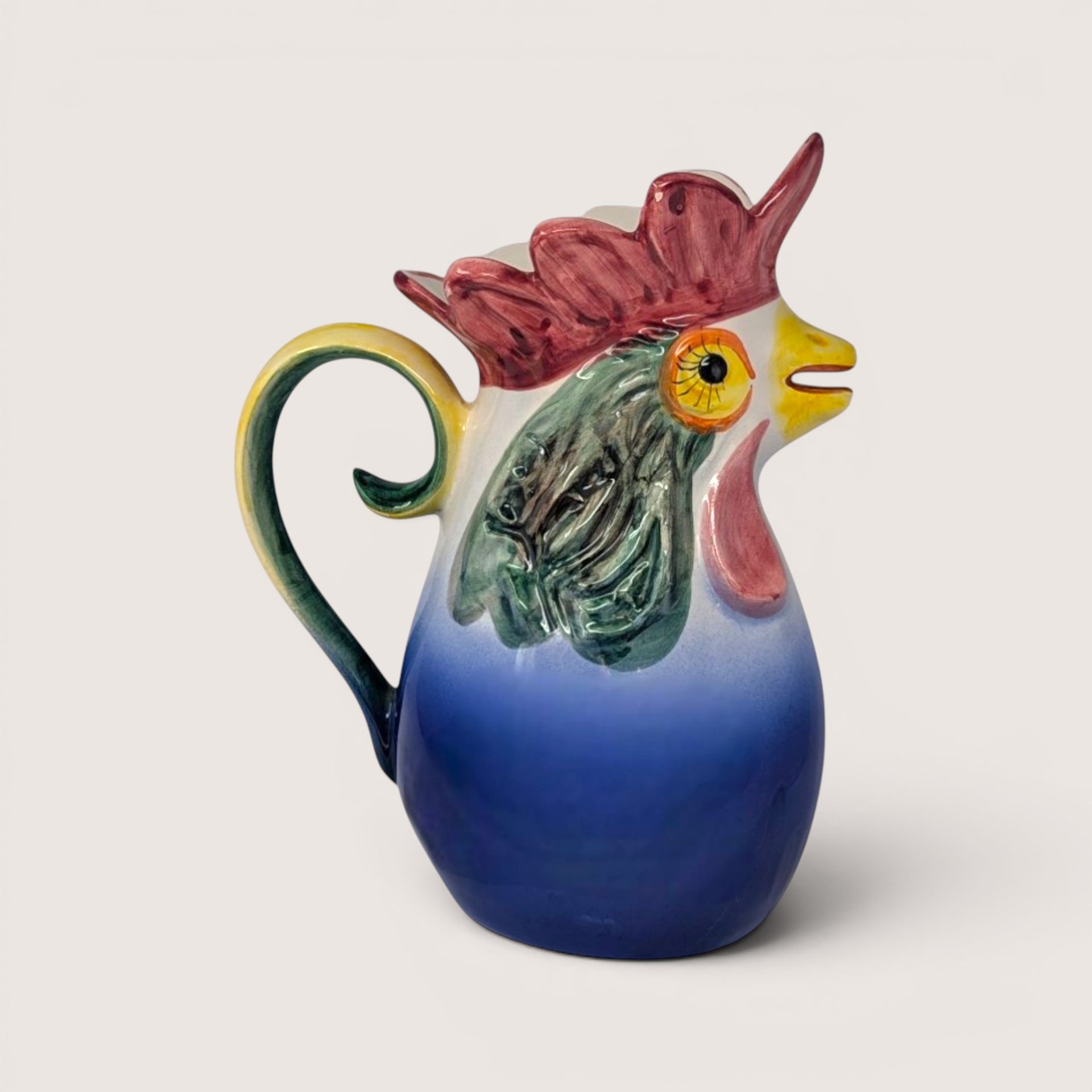 Vintage hand-painted ceramic rooster pitcher from Portugal with vibrant blue, red, and green glaze.