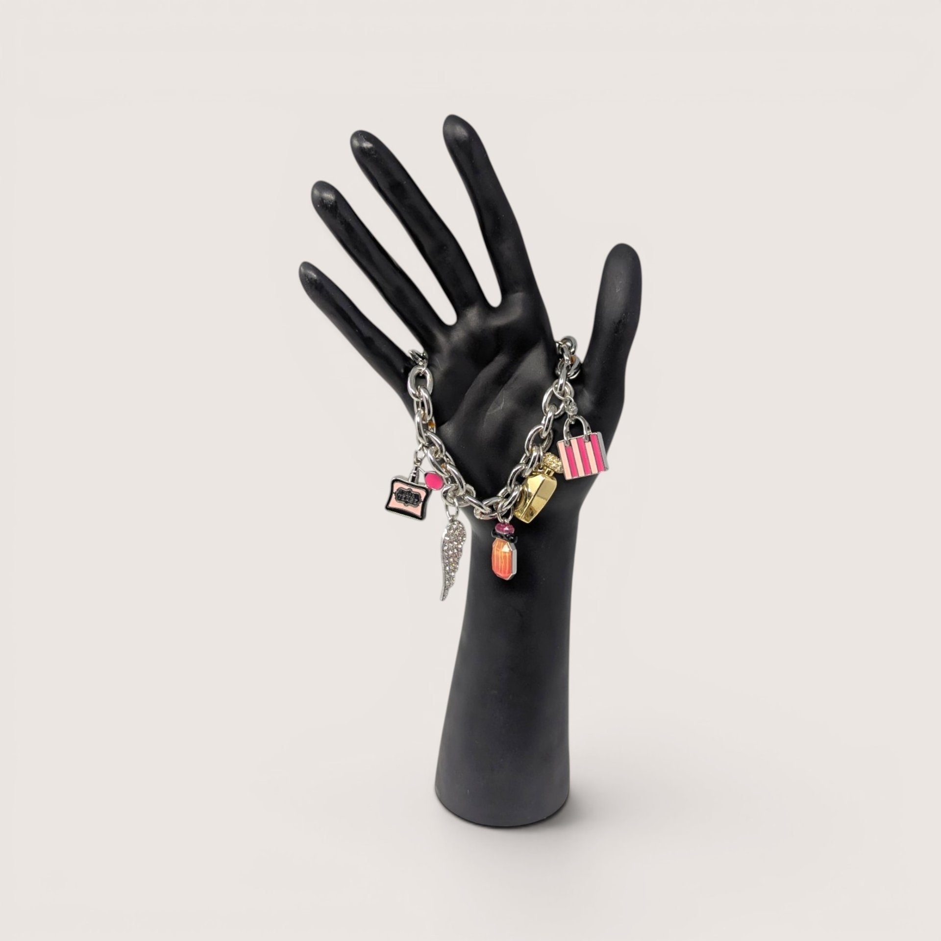 Y2K Victoria's Secret silver tone charm bracelet featuring iconic perfume and wing charms.