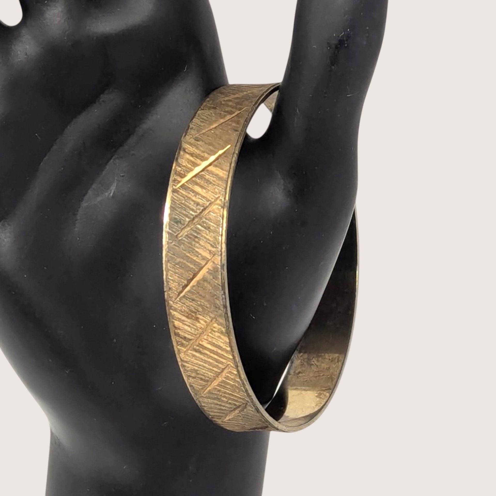 Vintage Park Lane gold tone textured metal bangle bracelet with geometric etching.