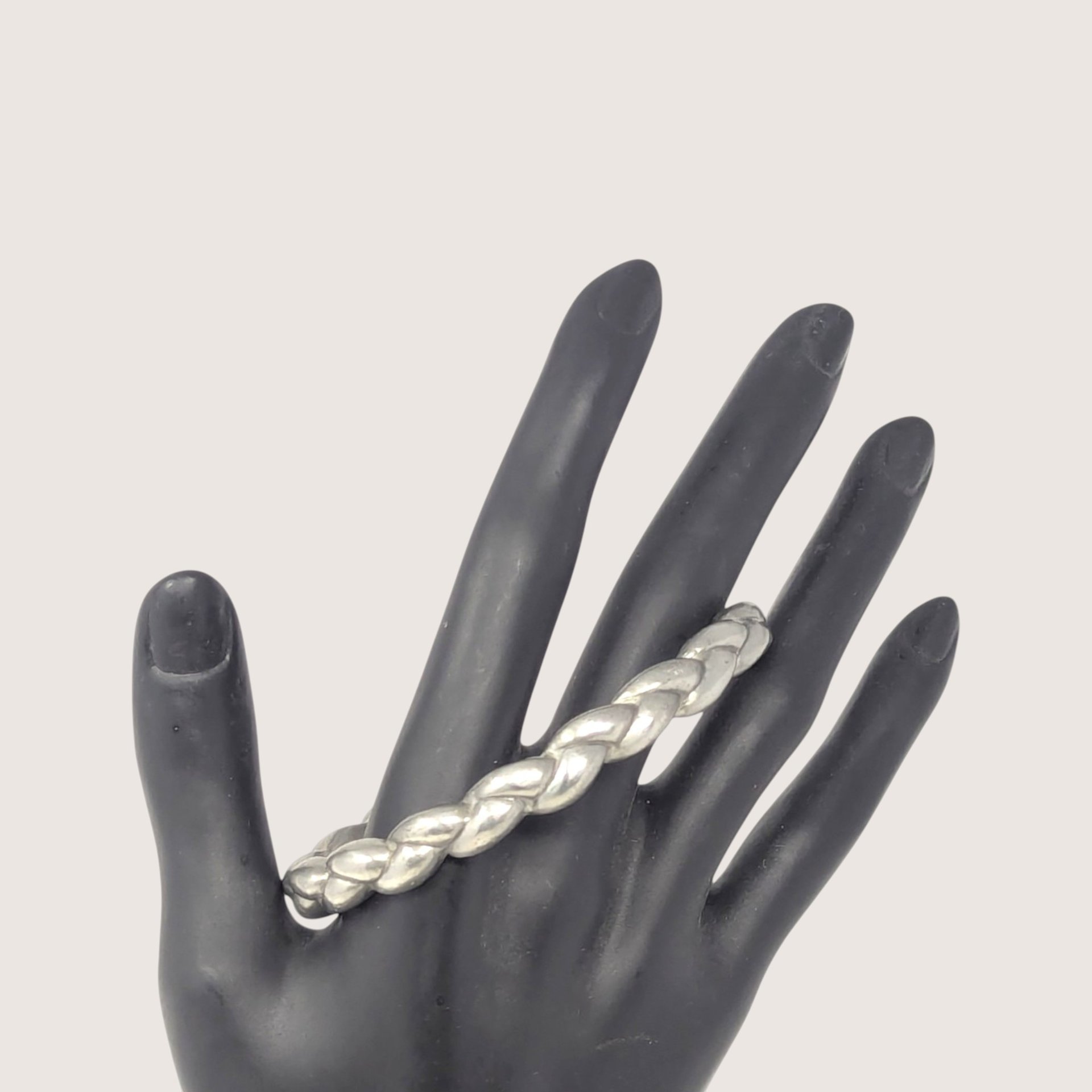 Vintage pewter braided bangle bracelet with a dimensional woven metal design.
