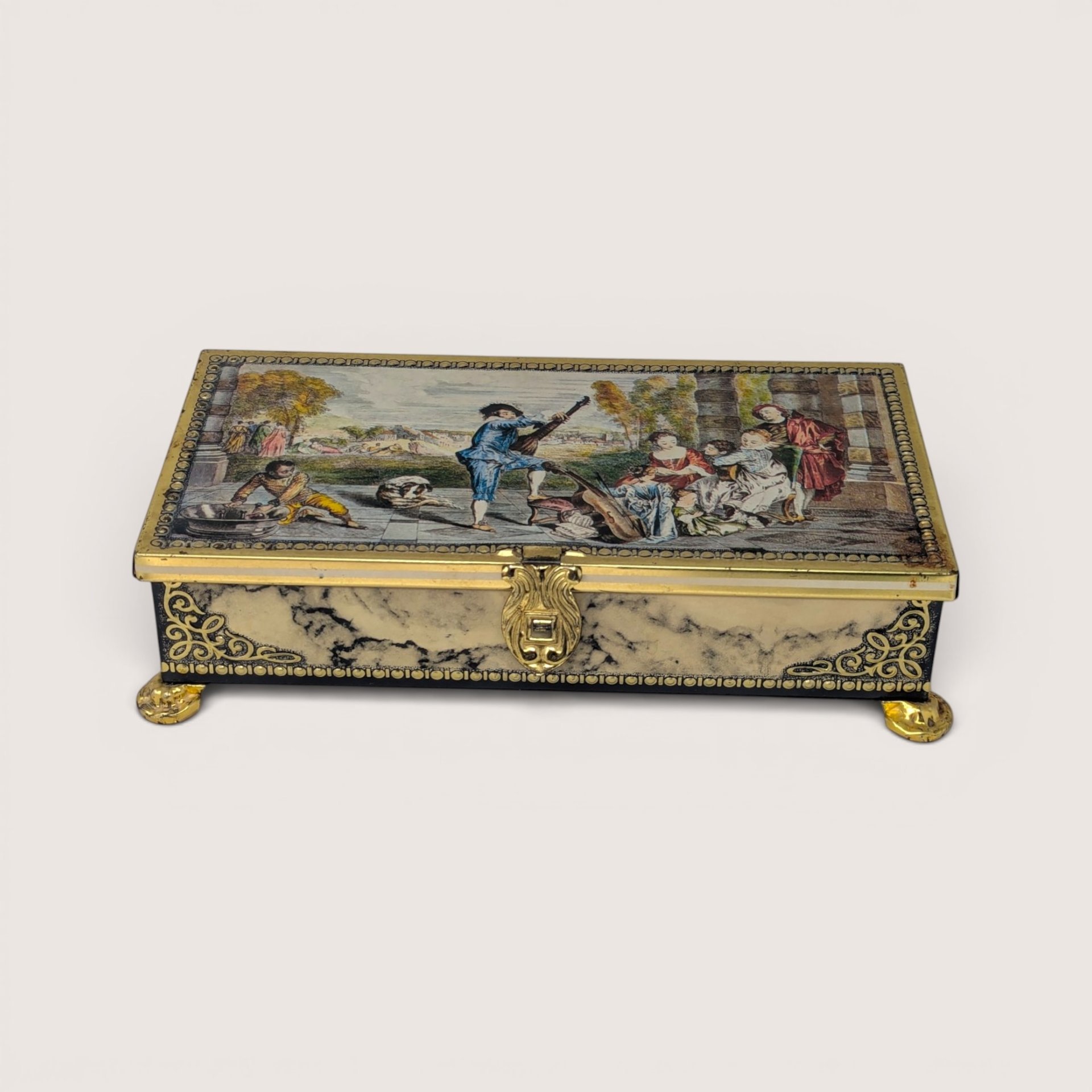 Vintage Jamin metal candy tin featuring a Renaissance scene lid and faux marble sides with gold feet.