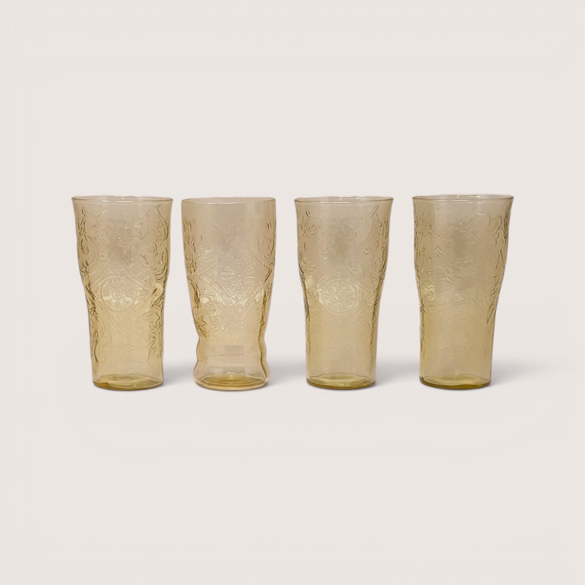 Set of four vintage Federal Glass amber tumblers in the Madrid depression glass pattern.