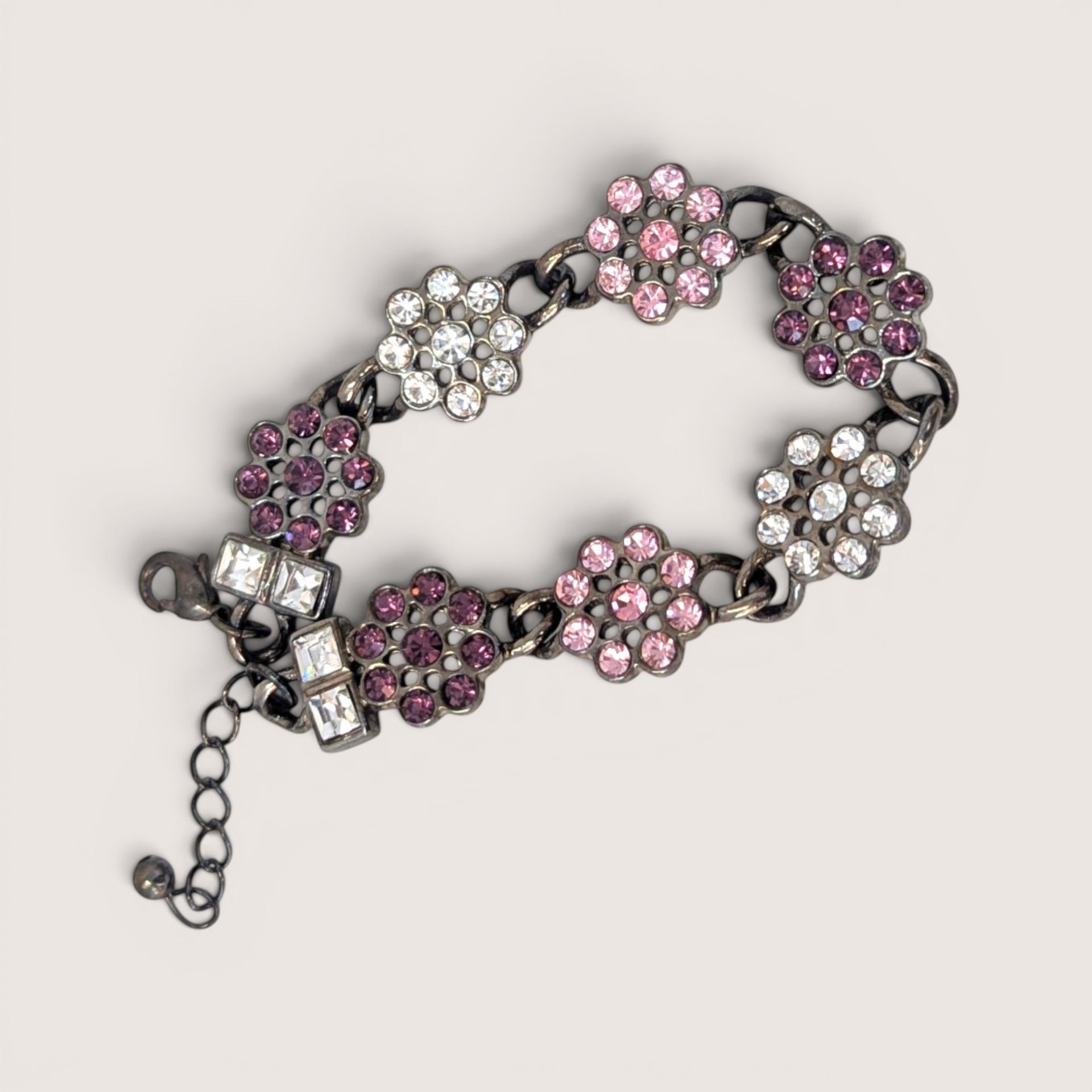 Vintage La Fleur rhinestone floral charm bracelet featuring flower links with pink and clear crystals.