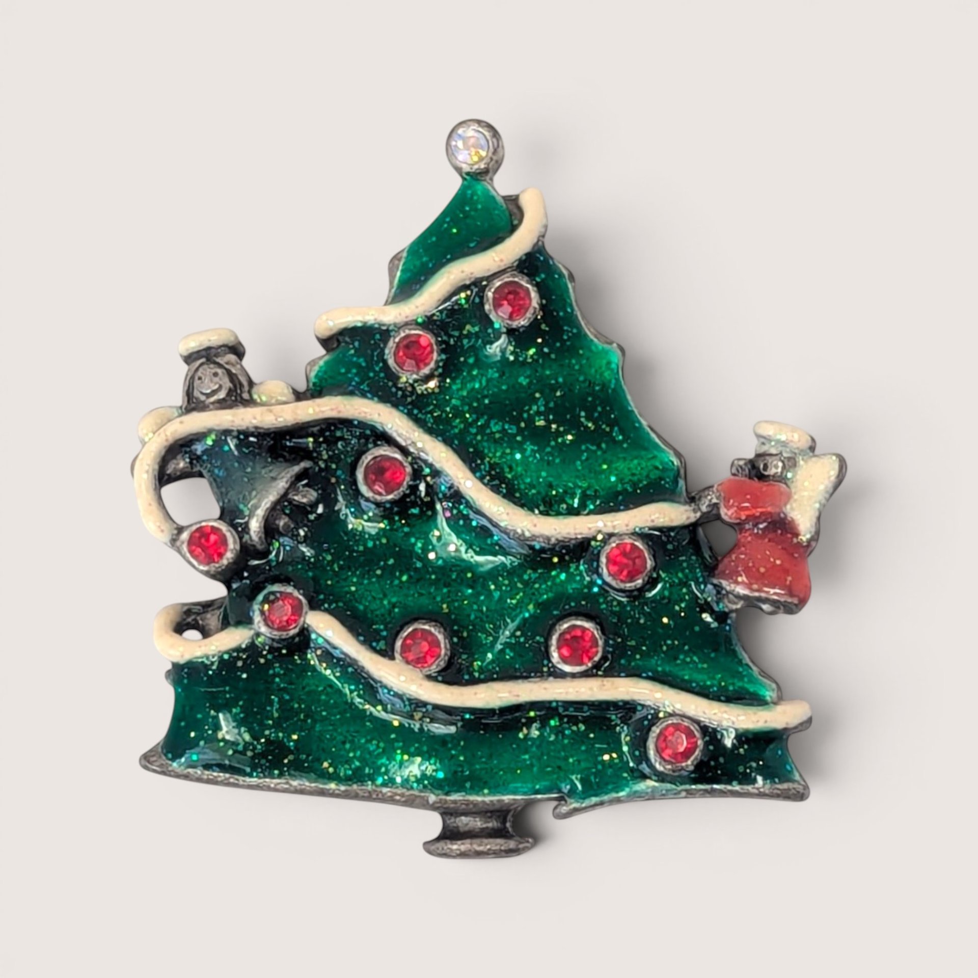 Vintage AJMC silver-tone green enamel Christmas tree brooch with red rhinestones and white garland.
