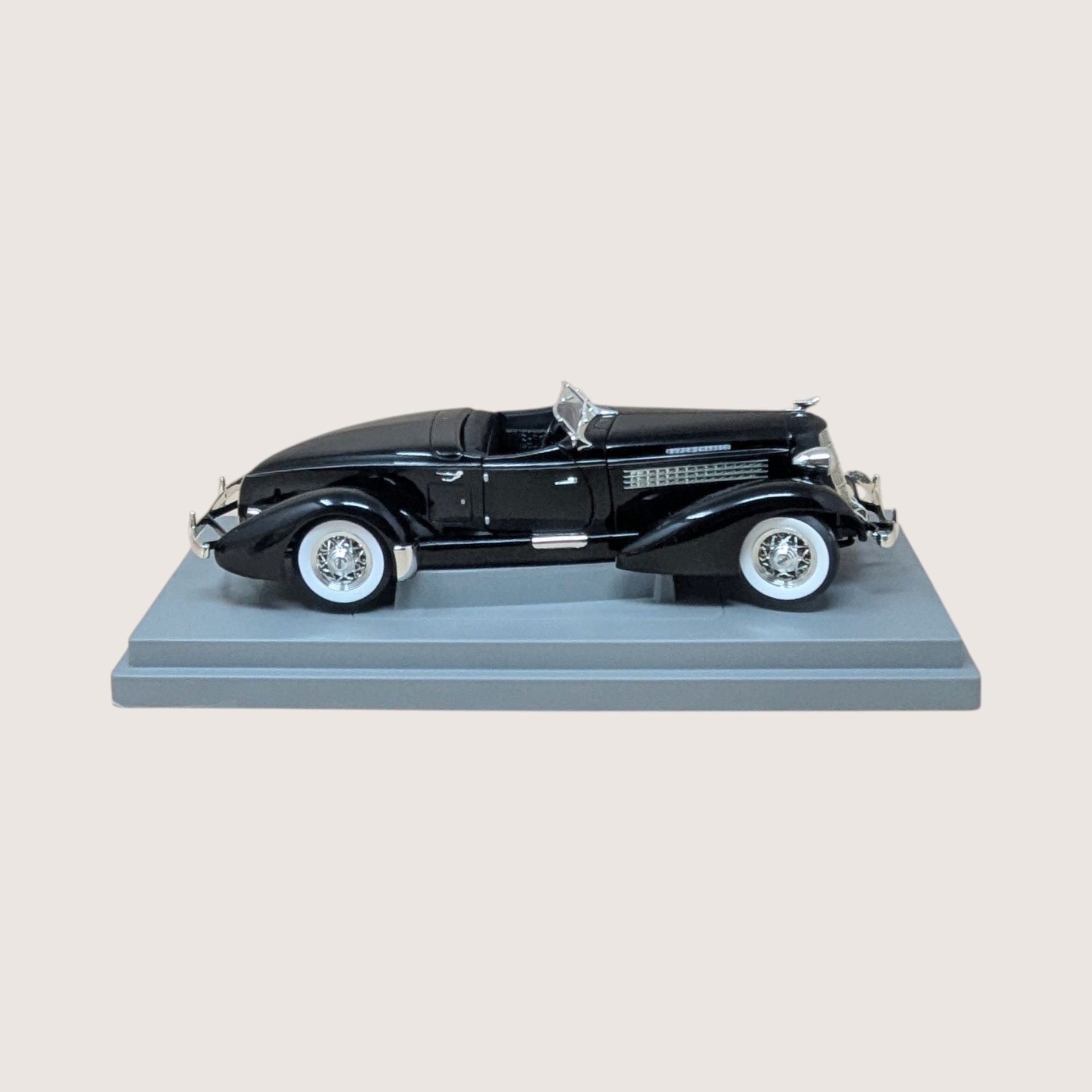 Vintage black ERTL American Muscle 1935 Auburn 851 Speedster diecast model in original worn display box.