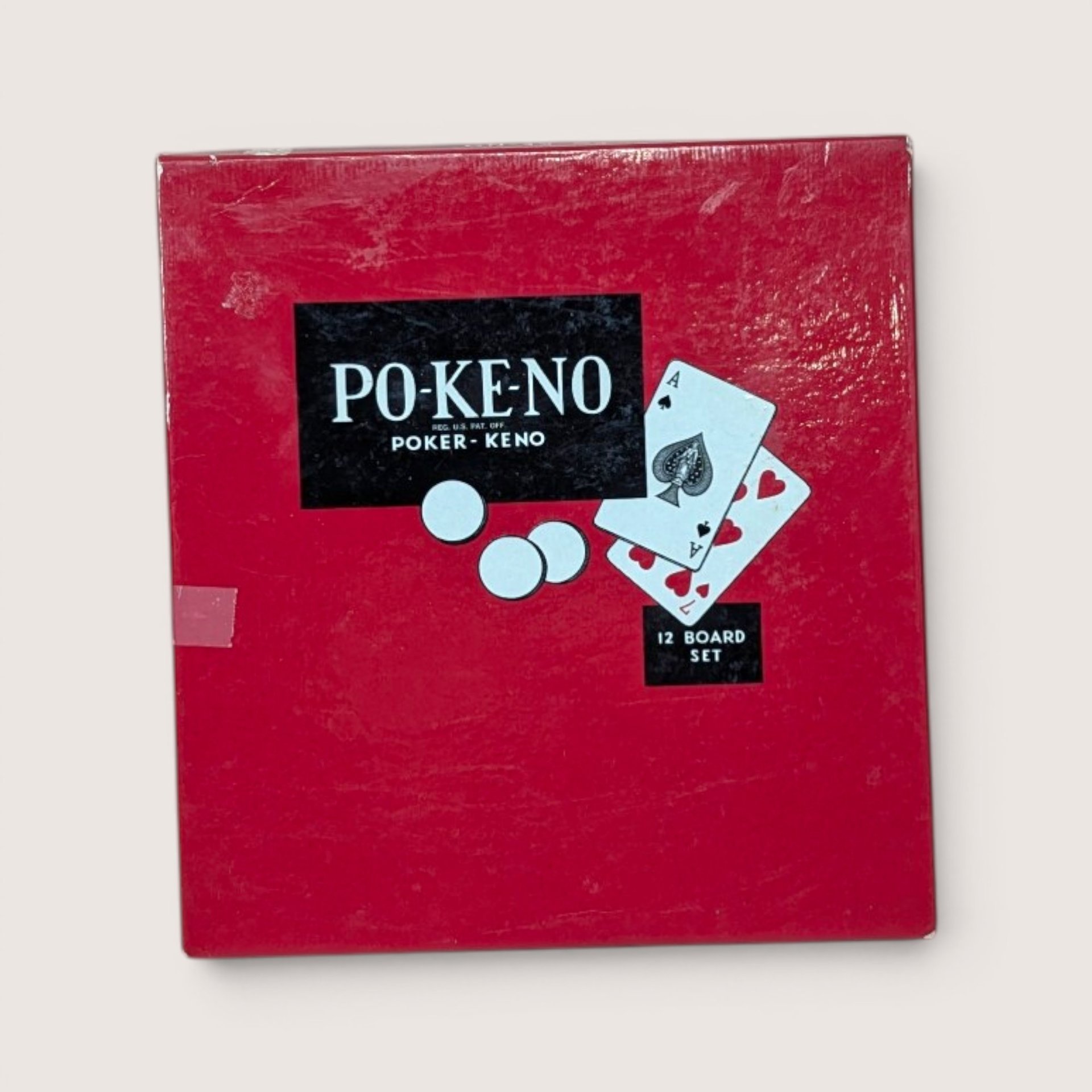 Vintage Po-Ke-No board game box featuring red cover and 12-board set graphics.