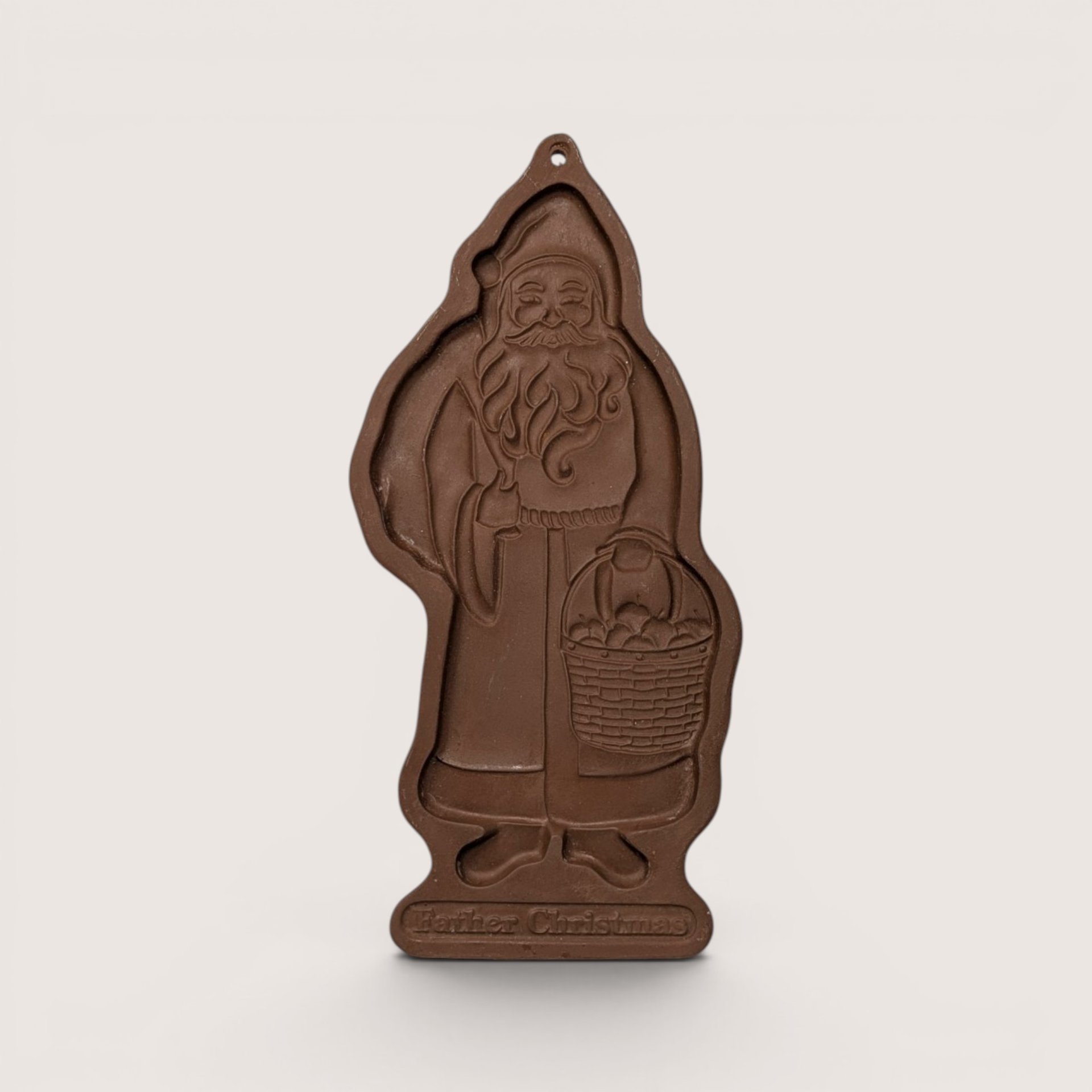 Vintage 1990 Longaberger terracotta Father Christmas cookie mold featuring an embossed Santa carrying a basket.