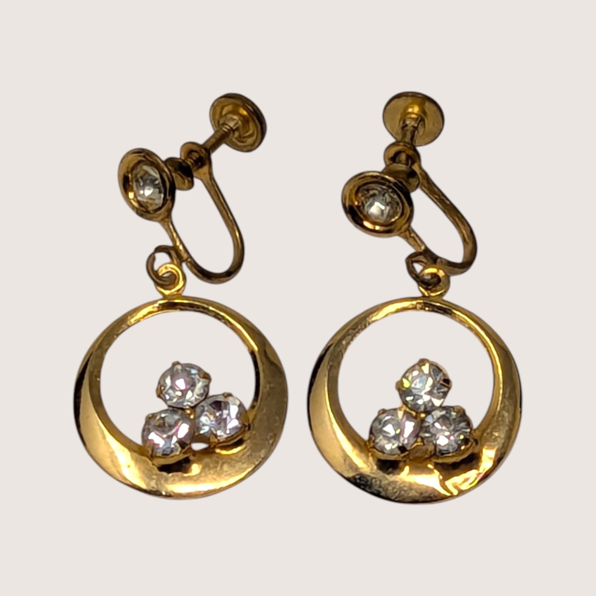 Pair of vintage 1950s gold-tone screw-back drop earrings with circular hoops and sparkling rhinestones.