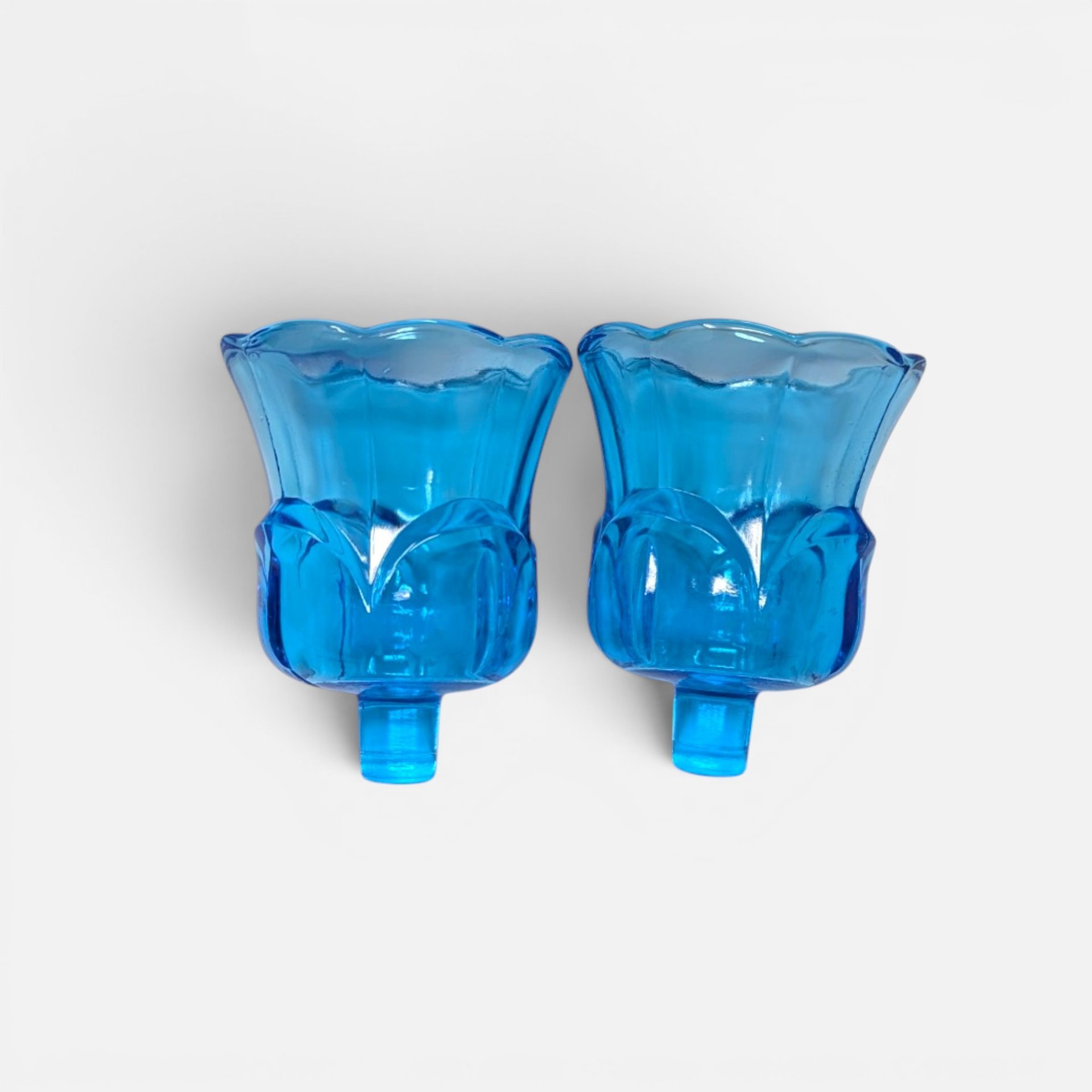 Pair of vintage vibrant blue glass tulip shaped peg votive candle holder cups with scalloped rims