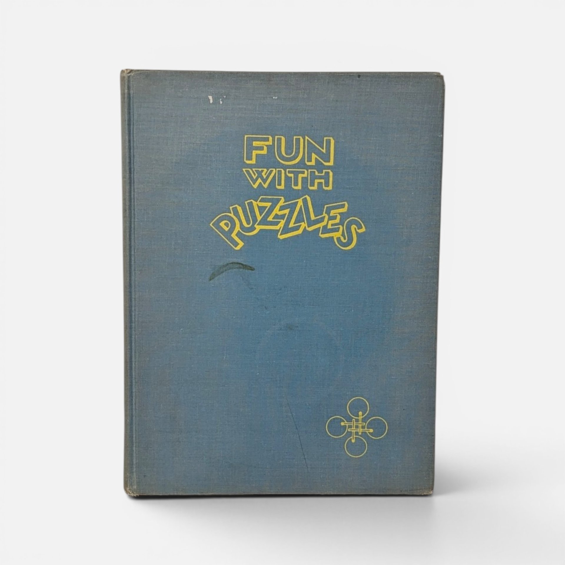 Vintage 1946 first edition hardcover book Fun with Puzzles by Joseph Leeming on a plain background.