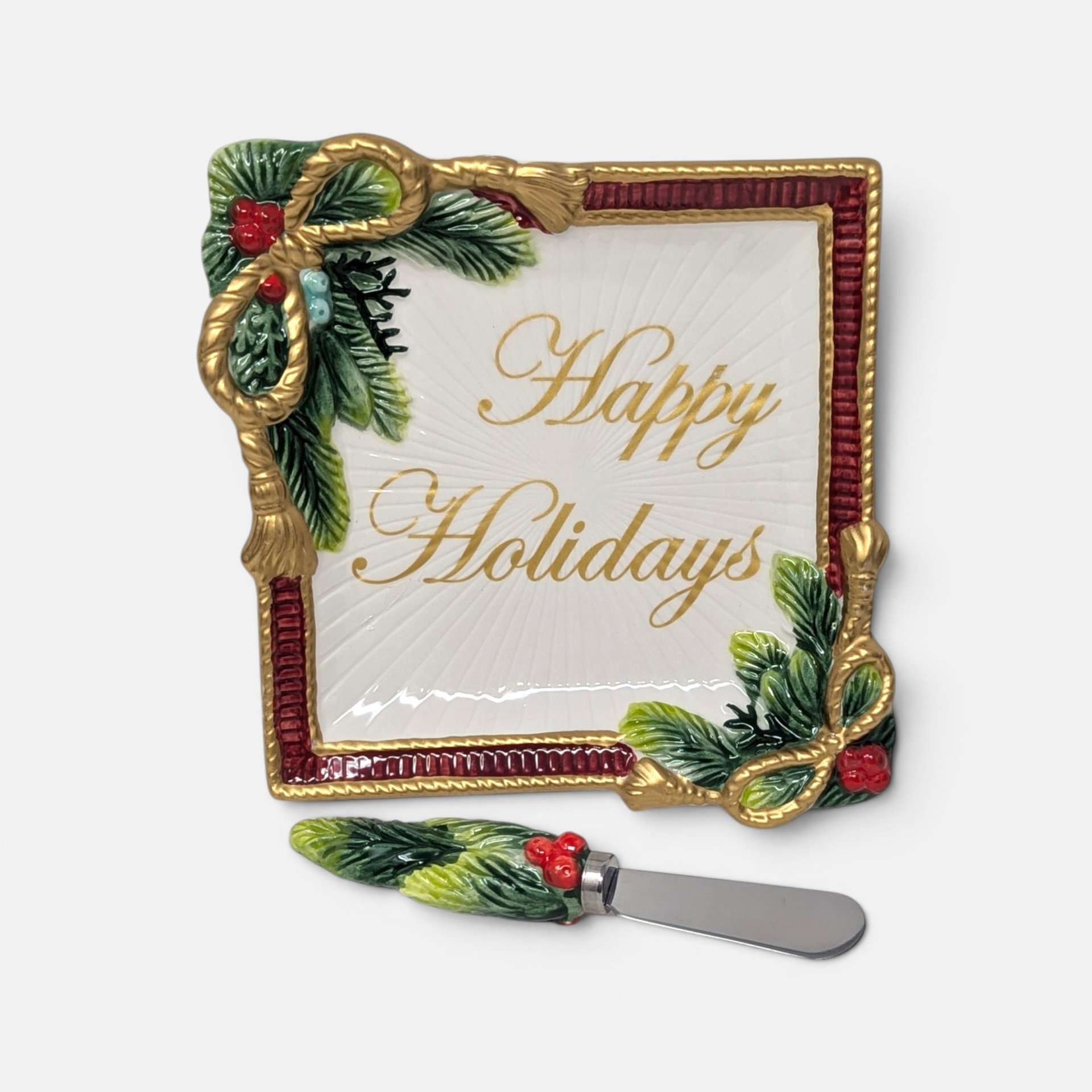 Vintage Fitz and Floyd "Happy Holidays" square ceramic plate with pine and ribbon details, accompanied by a matching spreader.