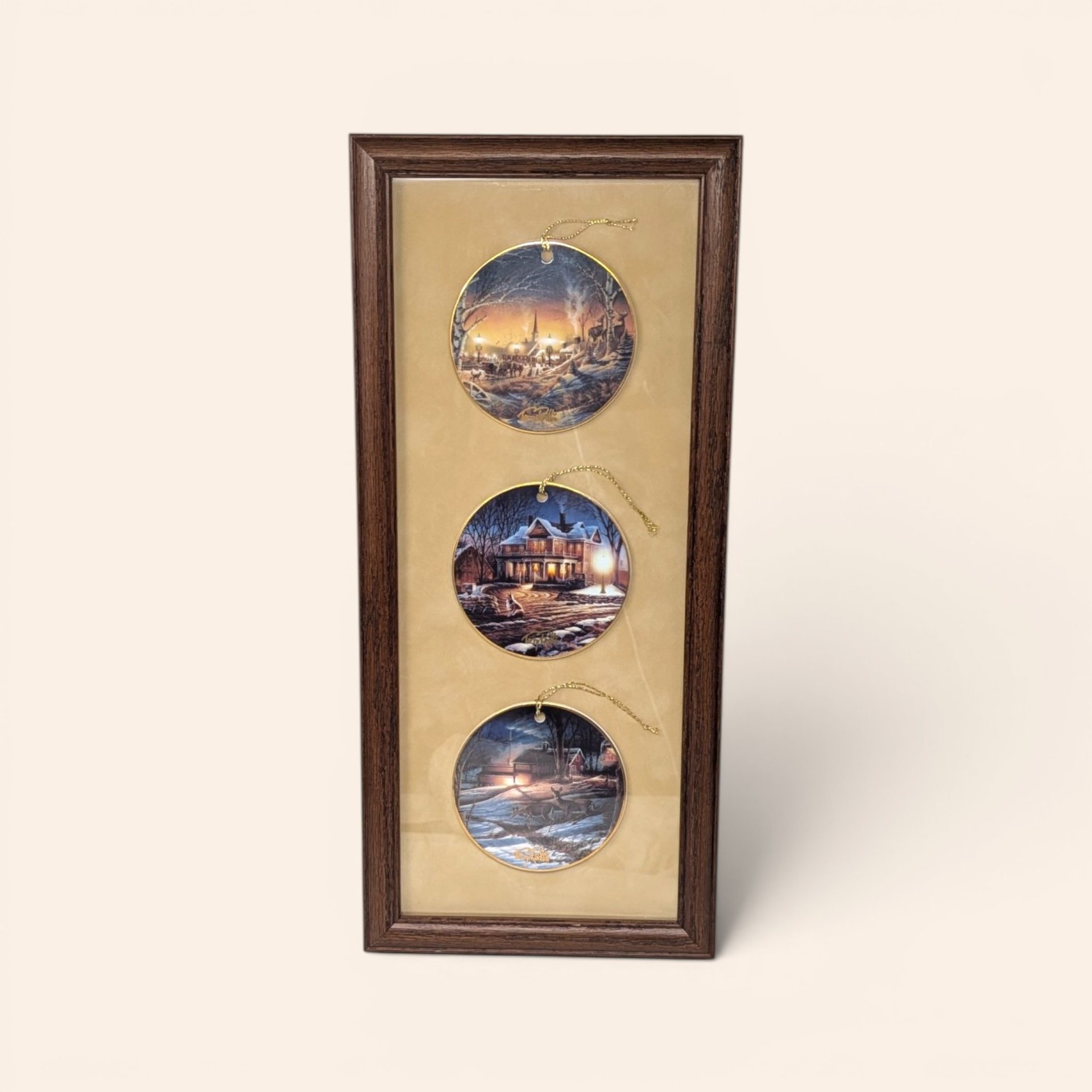 Vintage framed Terry Redlin ornament trio featuring winter scenes in a wooden frame.