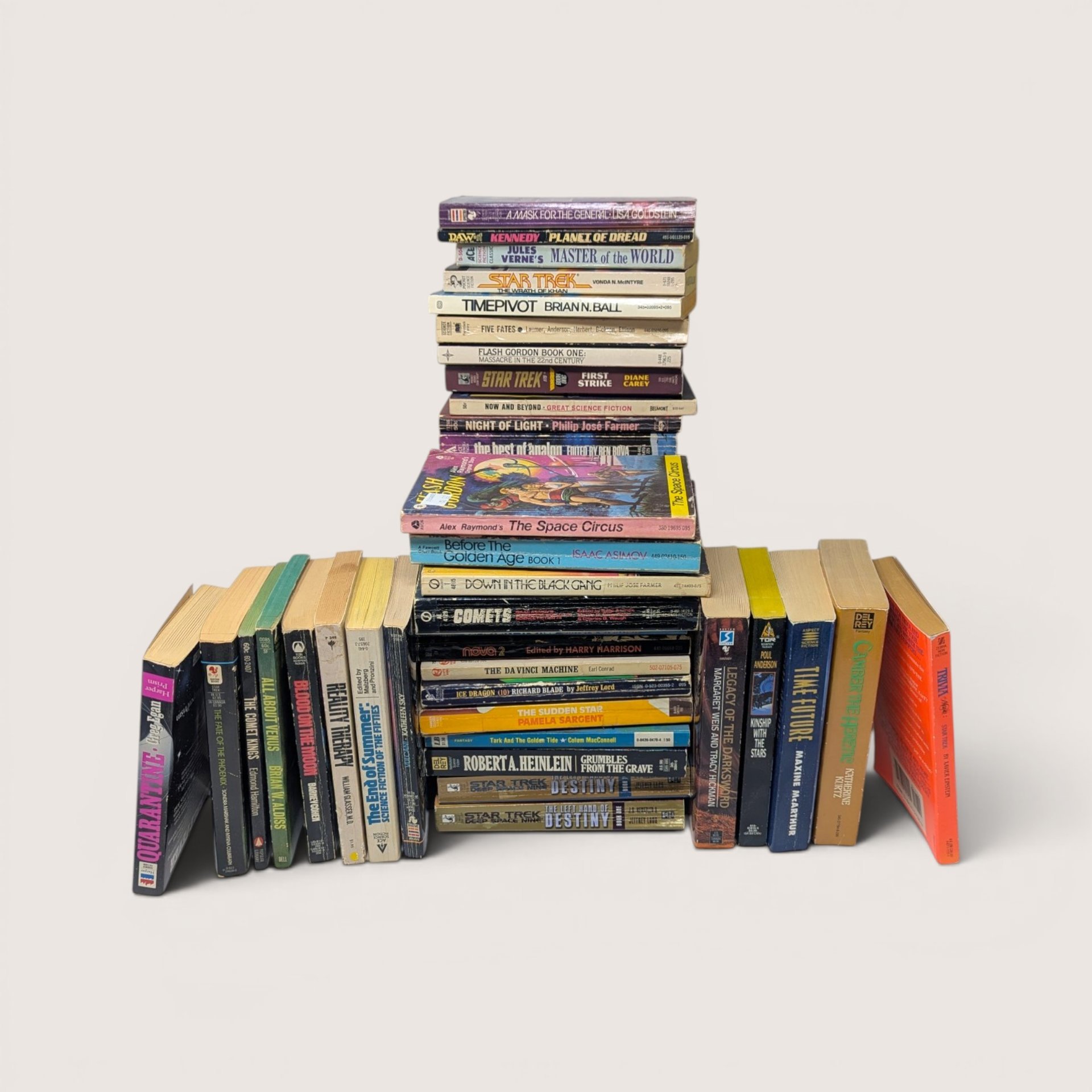 Large lot of 42 vintage science fiction paperback books stacked and arranged in rows.