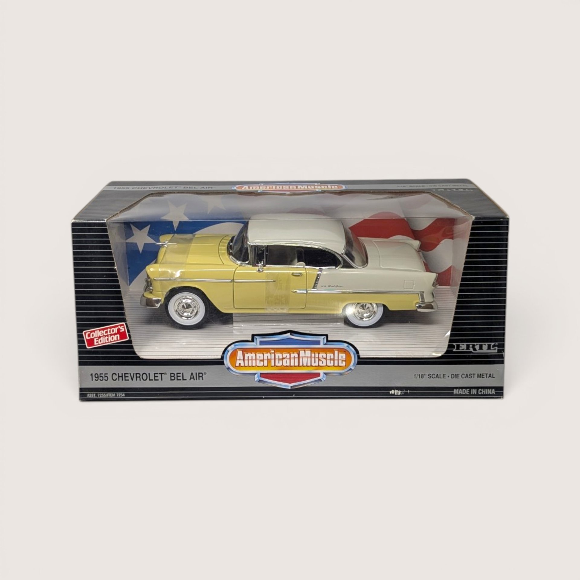 Vintage 1995 Ertl American Muscle yellow and white 1955 Chevrolet Bel Air die-cast vehicle in its original window box set against a plain linen background.