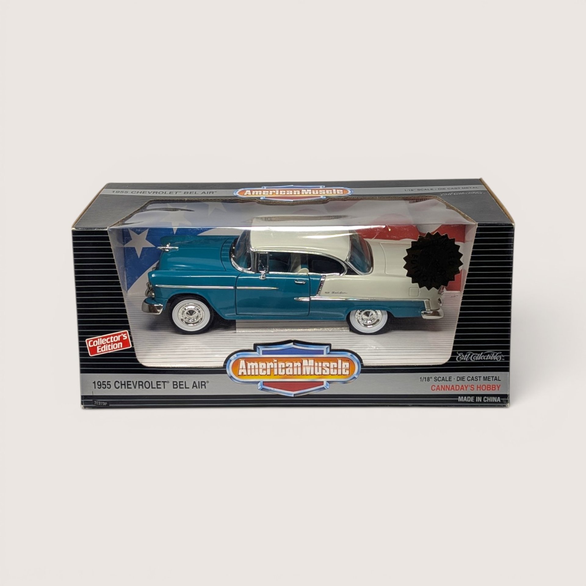 Vintage 1996 Ertl American Muscle blue and white 1955 Chevrolet Bel Air limited edition die-cast vehicle in its original window box set against a plain linen background.