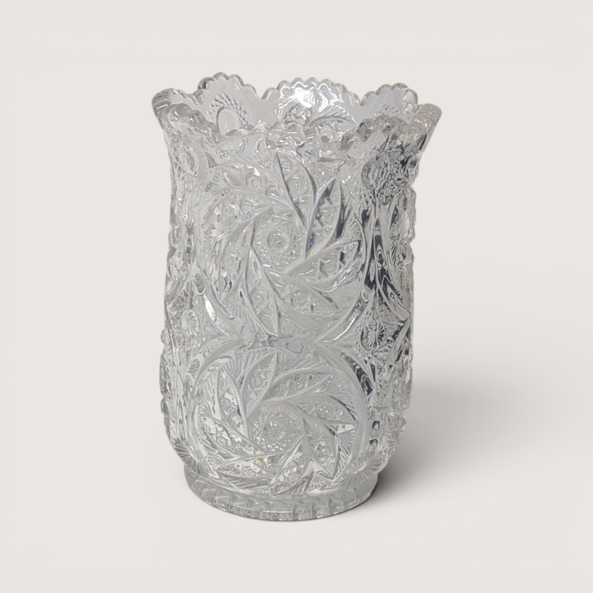 Stunning mid-century clear cut crystal vase with intricate starburst cut pattern and scalloped rim