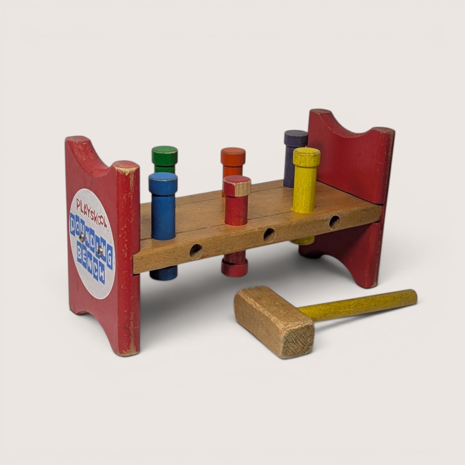 Vintage wooden Playskool pounding bench with colored pegs and matching wooden hammer