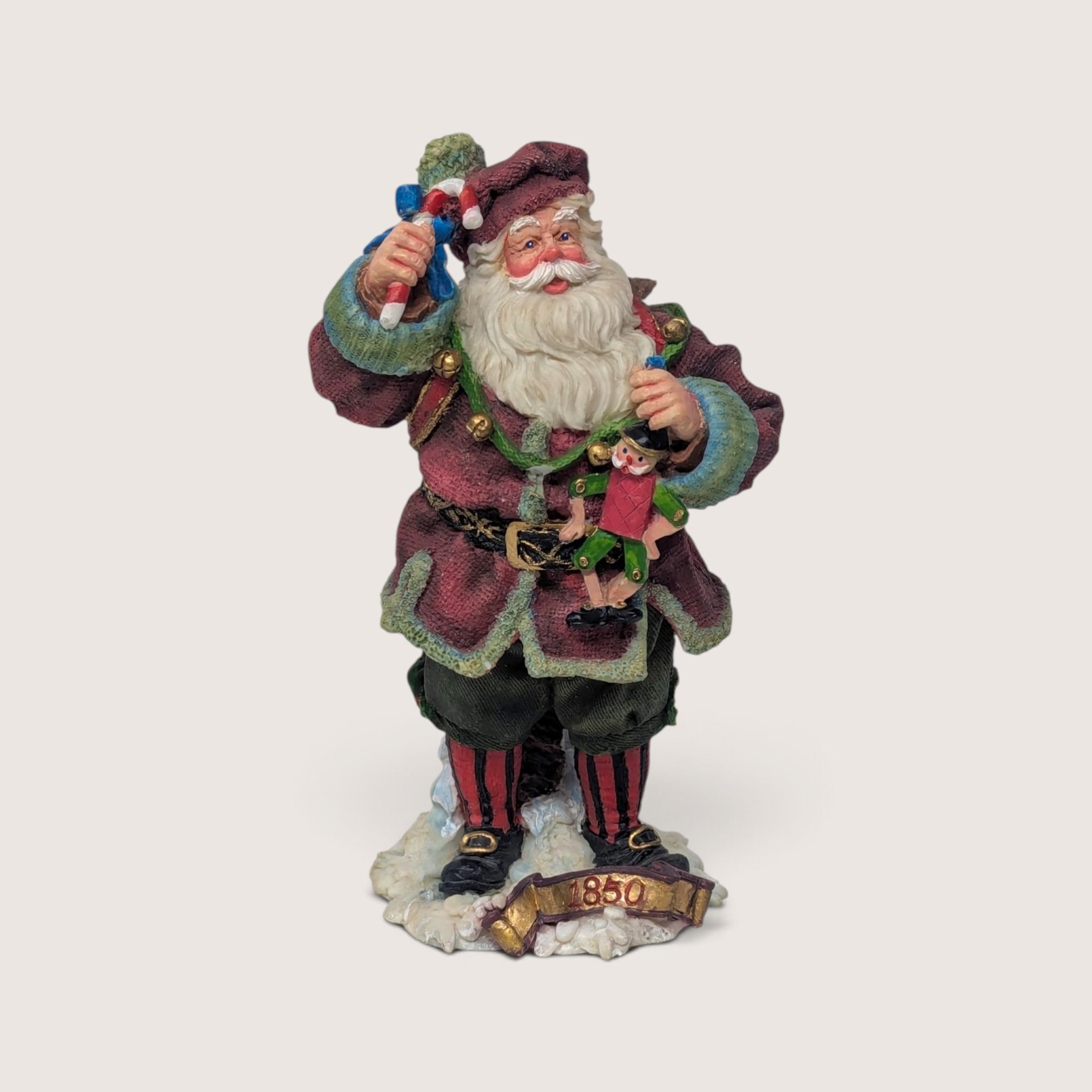 Vintage 1993 Roman American Santas Through the Decades 1850 figure holding toys with base banner