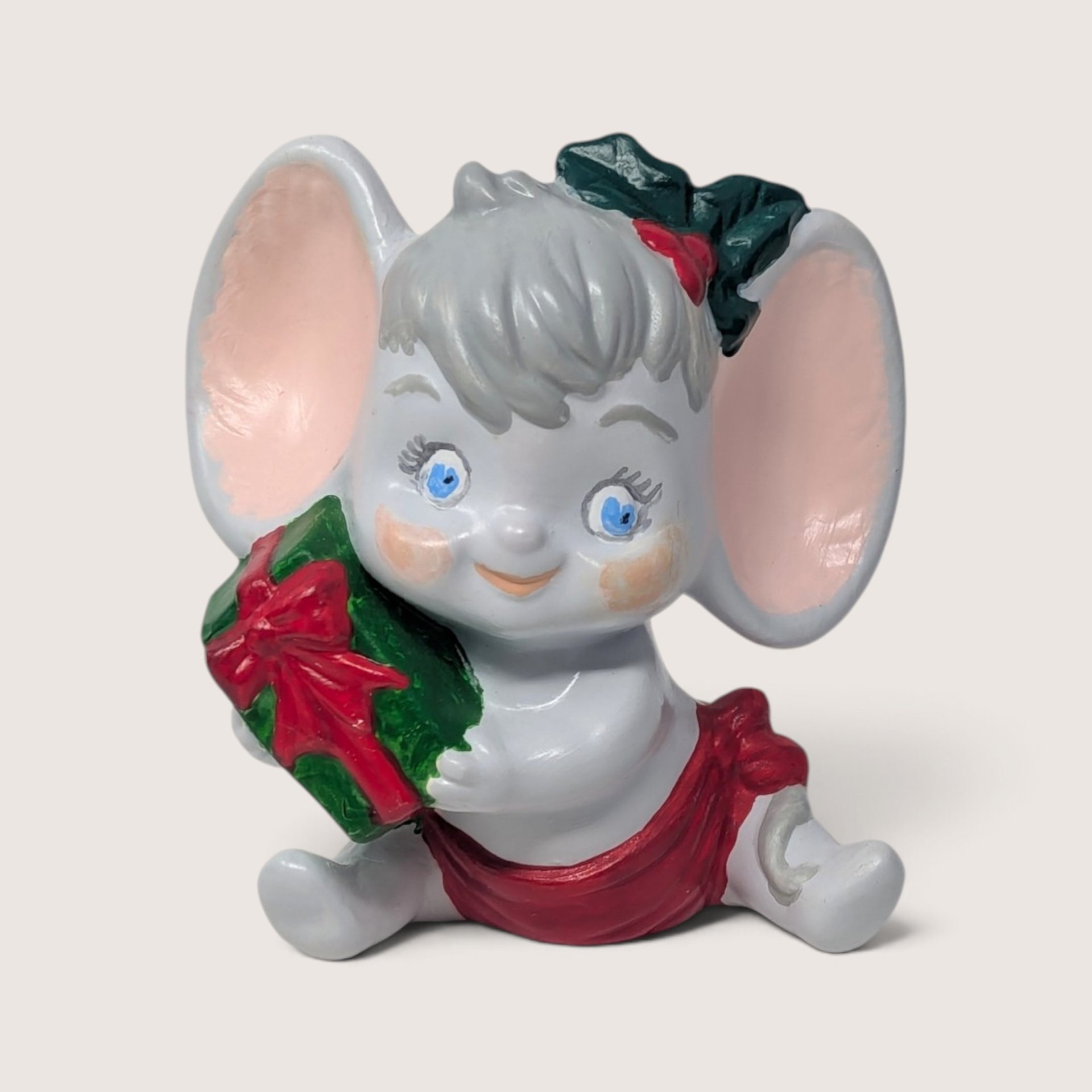 Vintage handpainted ceramic mouse figurine holding a green present with a red bow
