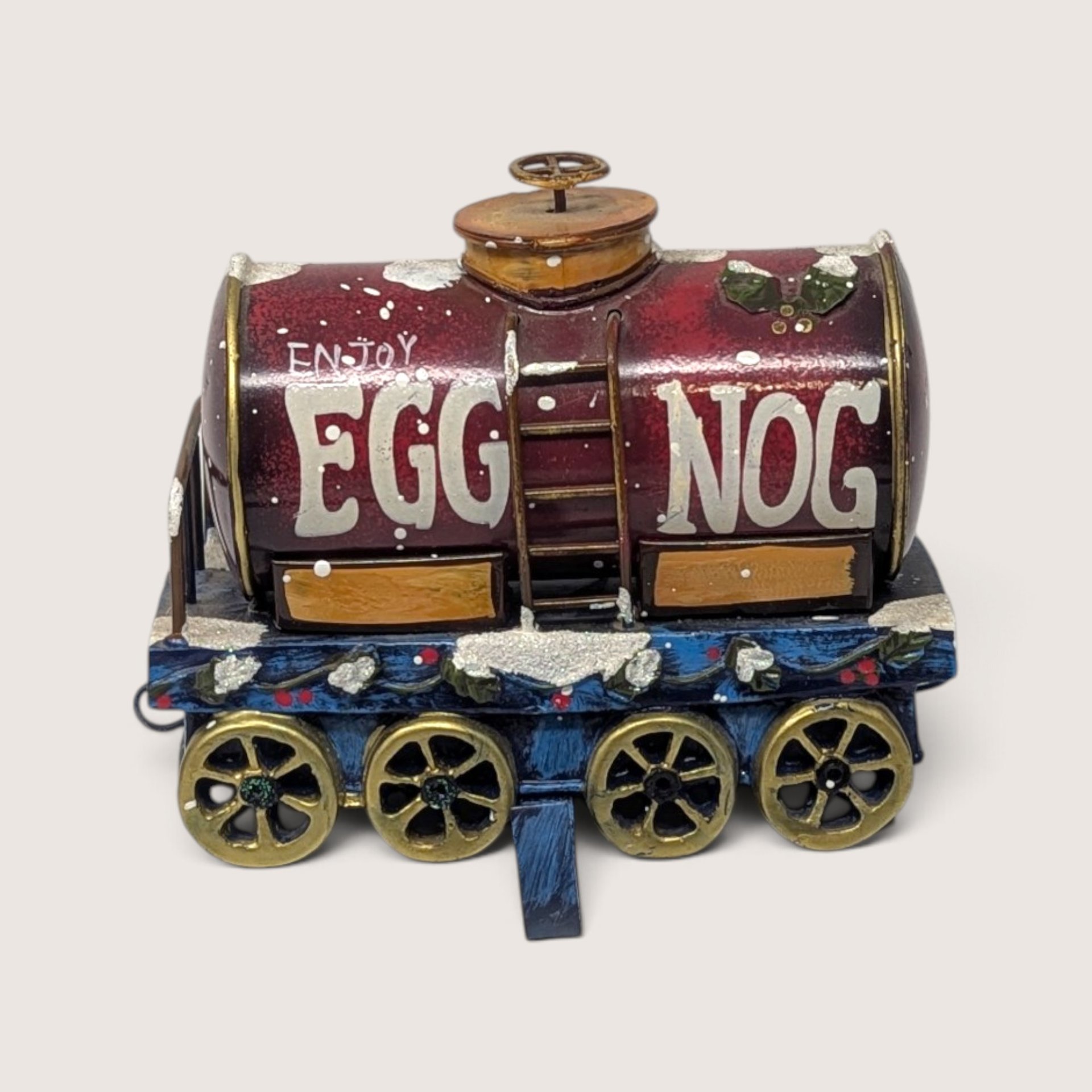 Vintage Enjoy Eggnog train Christmas stocking holder made of metal and resin.