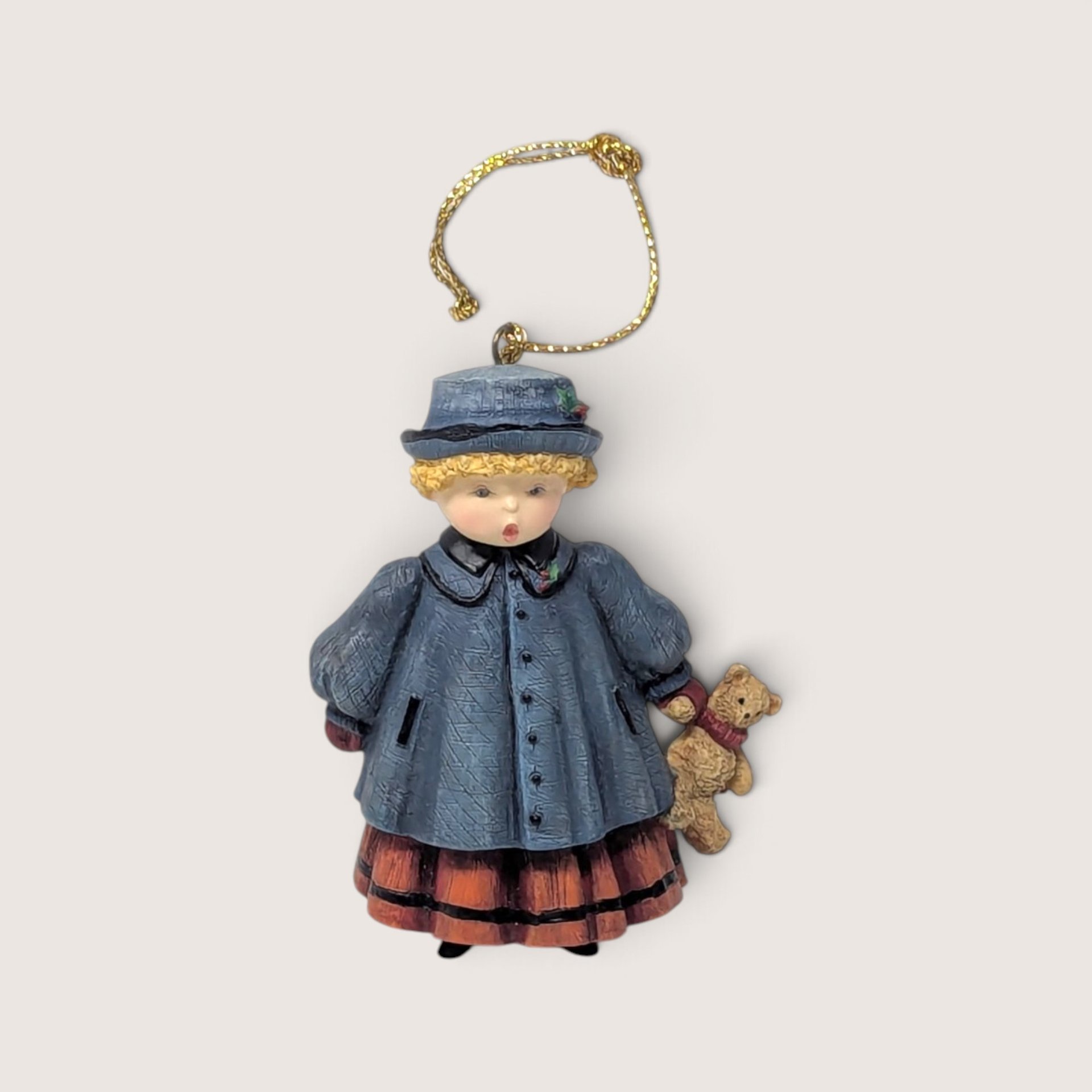 Vintage 1998 Lang and Wise Praise resin Christmas tree ornament holding a teddy bear.