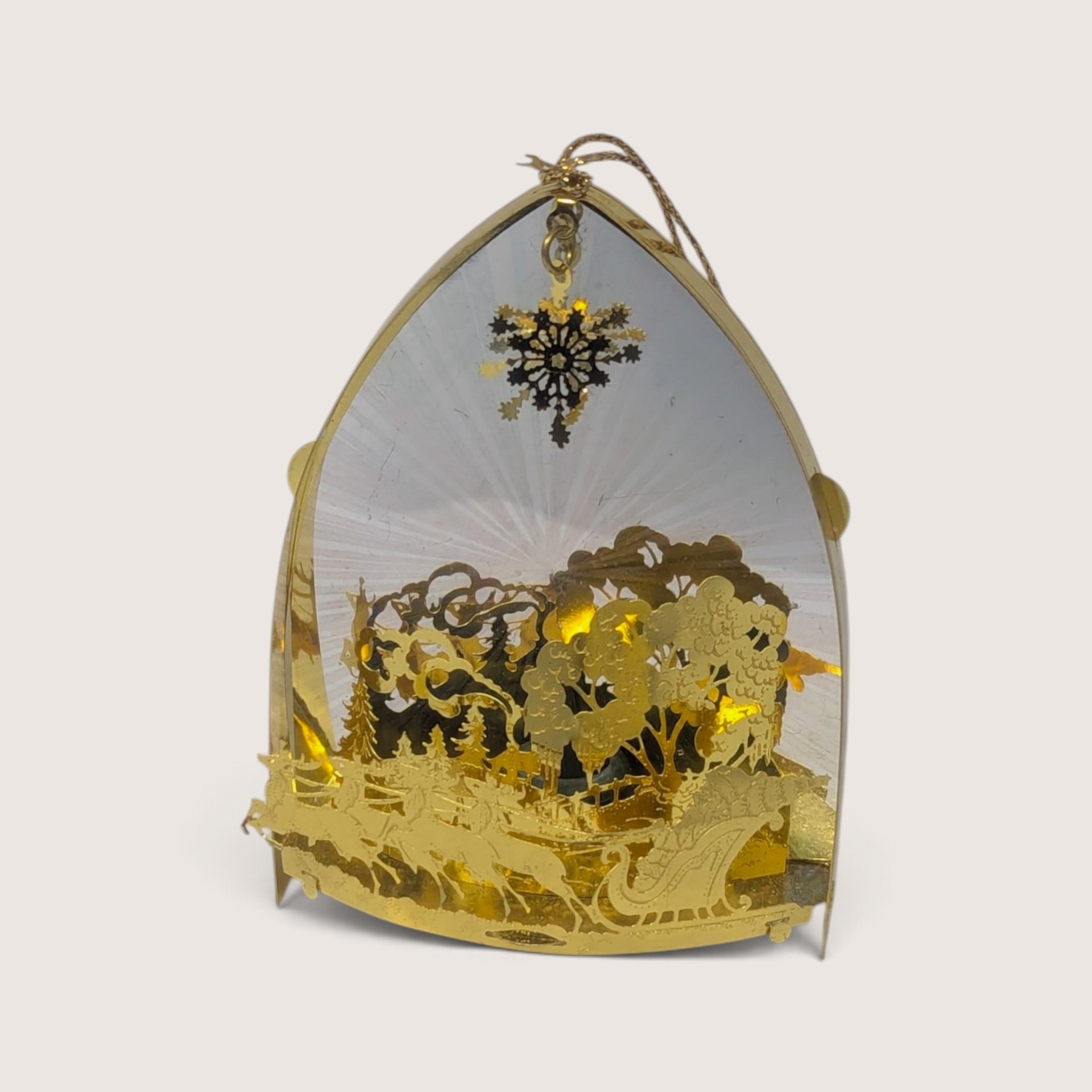 Vintage gold laser-cut metal Christmas ornament featuring Santa on a sleigh with a bottom light port.