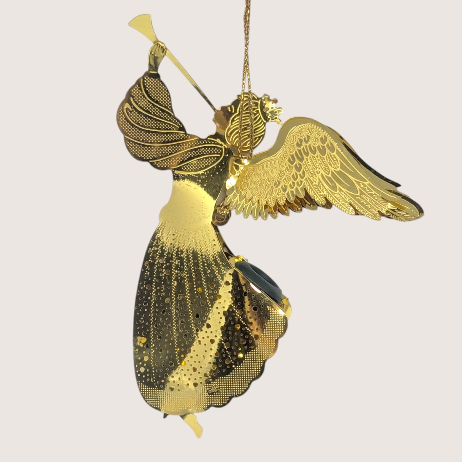 Vintage gold-tone laser-cut metal angel ornament featuring detailed wings, a trumpet, and an opening for a tree light.