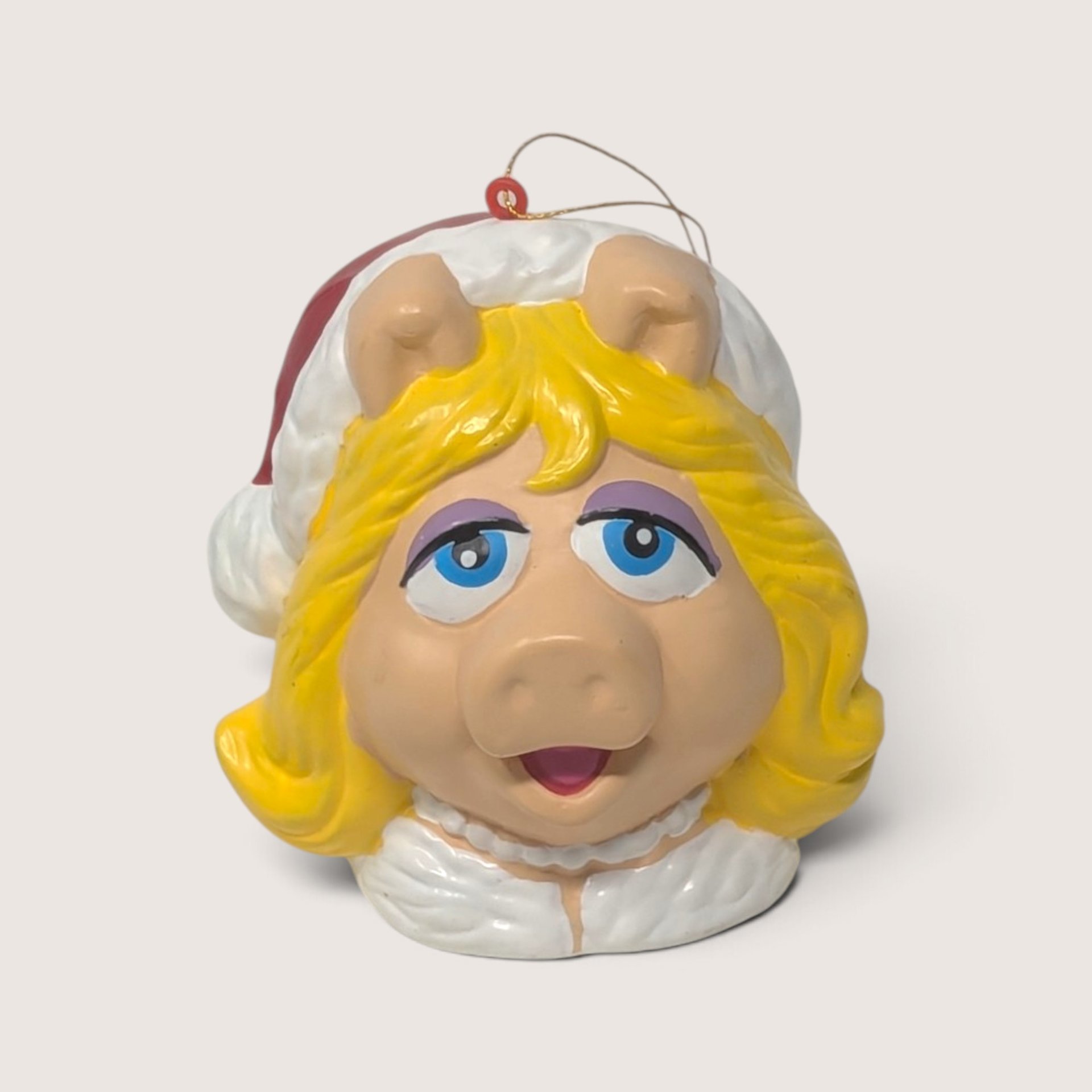 Vintage plastic Muppets Miss Piggy Christmas ornament featuring her classic look and a festive Santa hat.