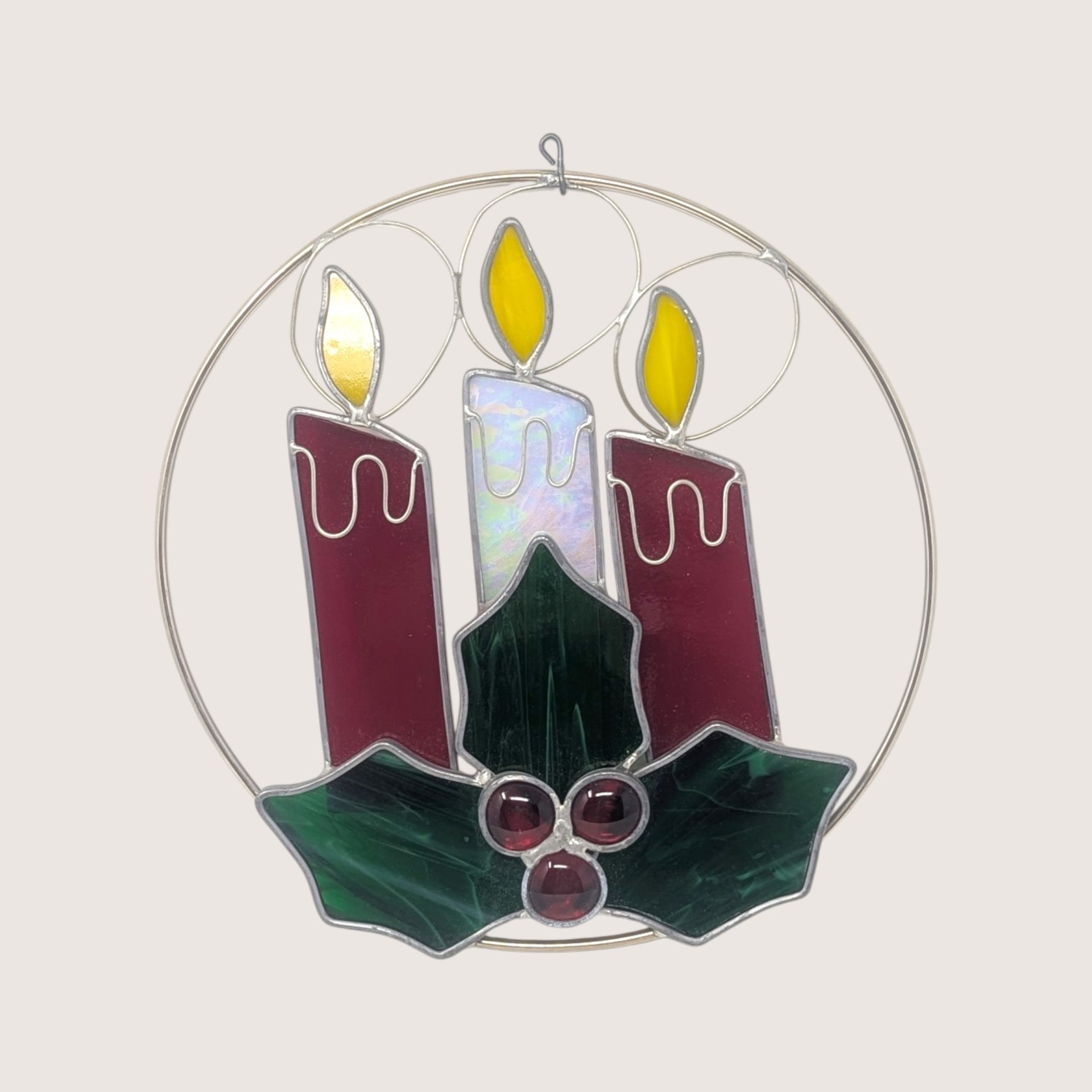 Vintage iridescent stained glass Christmas candles suncatcher featuring green holly leaves, red wax drips, and glass jewel berries.