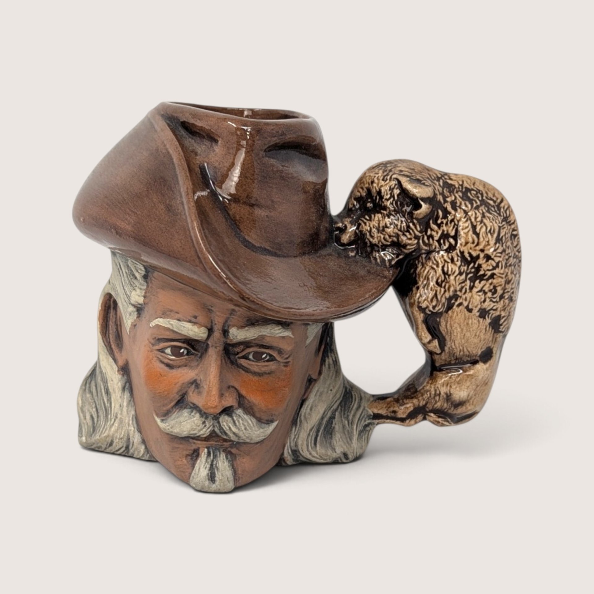 Vintage hand-painted ceramic character mug depicting Buffalo Bill Cody with a sculpted bison handle and "DAD" inscribed on the base.
