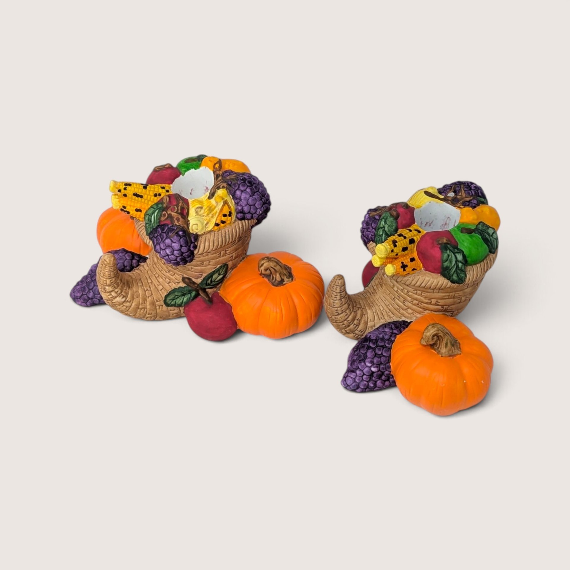 Vintage pair of Partylite ceramic cornucopia taper candle holders featuring sculpted harvest fruit accents.