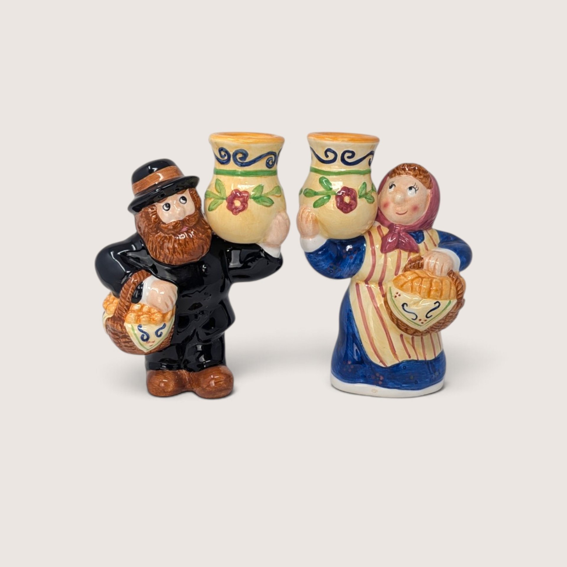 Vintage Lotus handcrafted ceramic Thanksgiving man and woman taper candle holders holding harvest jugs.