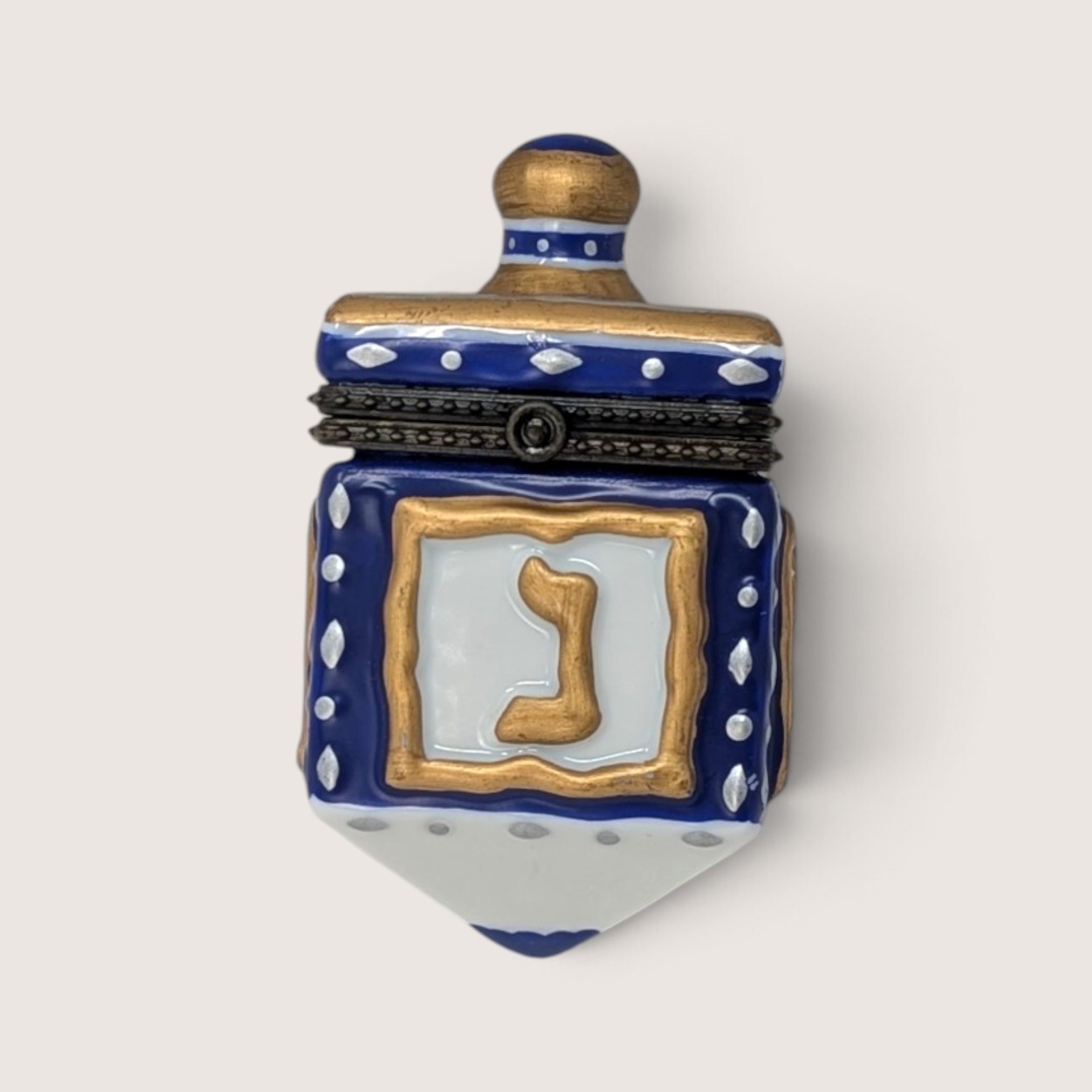 Vintage ceramic Hanukkah dreidel hinged trinket box in cobalt blue and gold with Hebrew lettering.