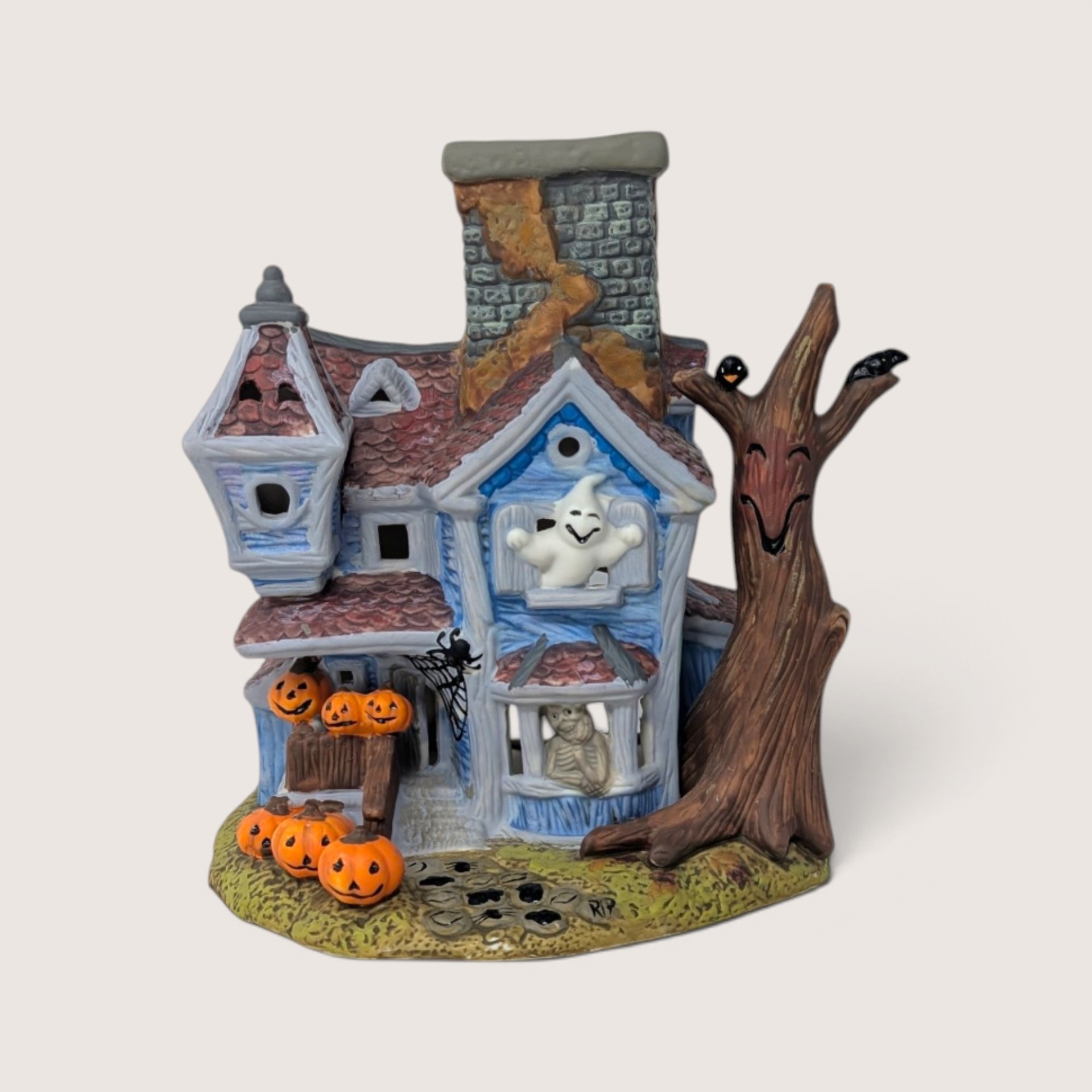 Vintage 1990s PartyLite ceramic haunted house tealight candle holder featuring pumpkins and a ghost figure.