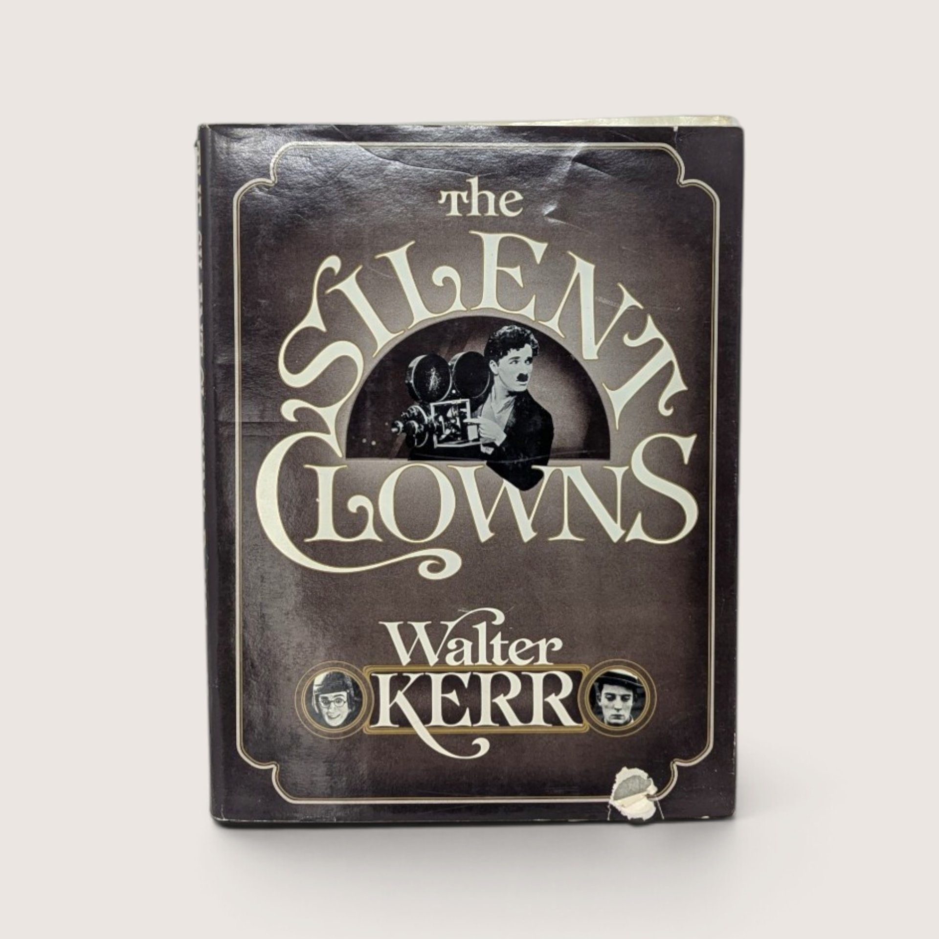 Vintage 1975 hardcover book titled The Silent Clowns by Walter Kerr with its dust jacket featuring a vintage photograph of Charlie Chaplin.
