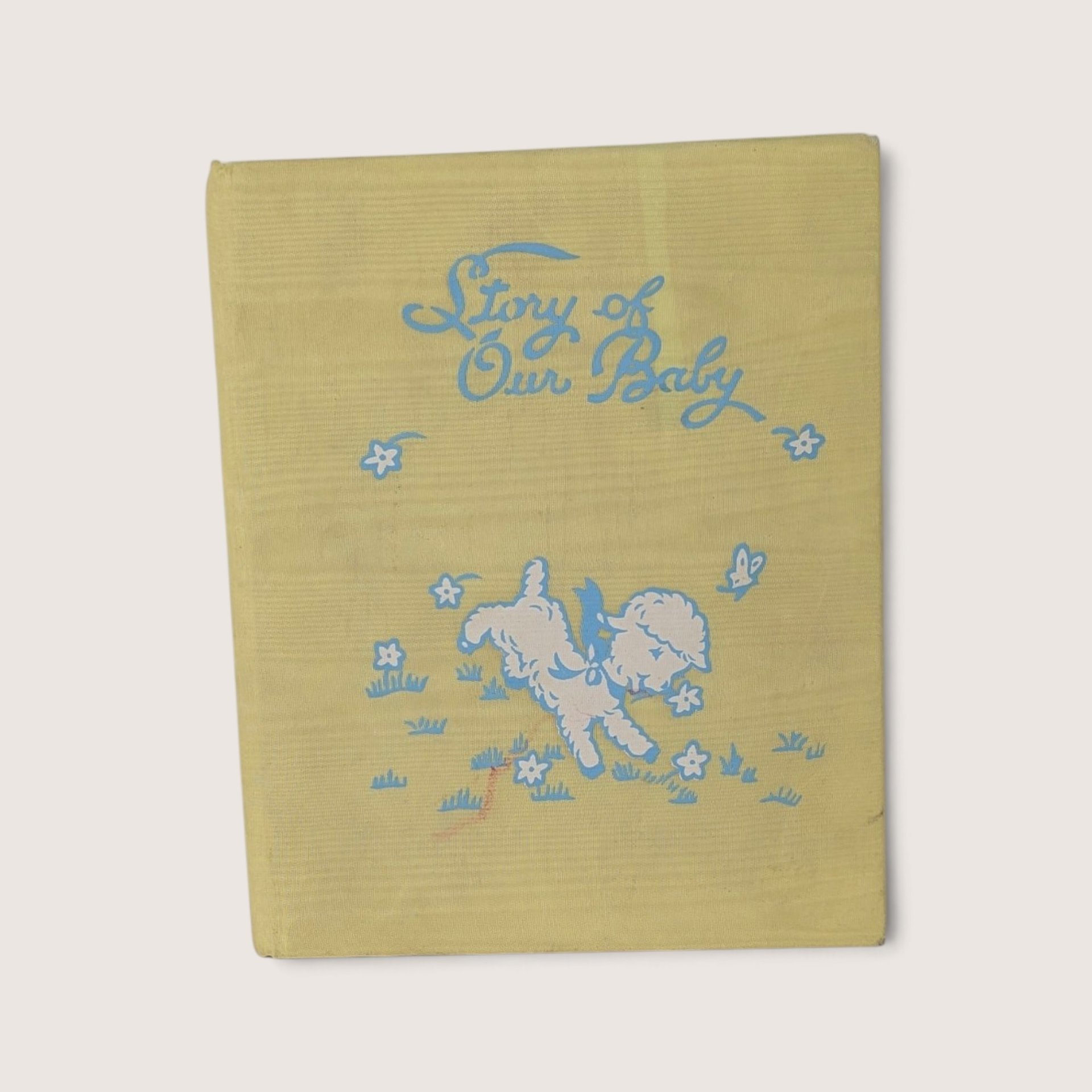 Vintage 1971 baby memory book titled The Story of Our Baby featuring illustrated illustrations by The Hendersons and a yellow fabric cover.
