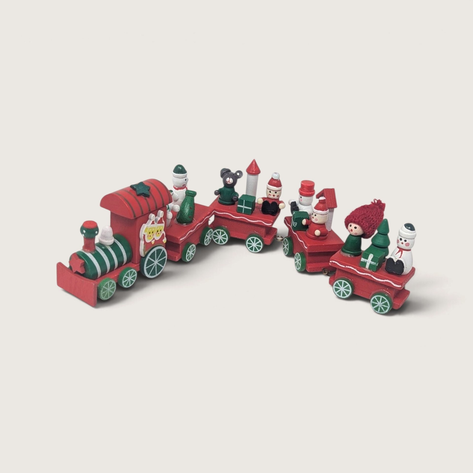 A vintage small wooden Christmas train set with a red engine and five trailing cars carrying miniature snowmen, trees, and gifts against a neutral background.