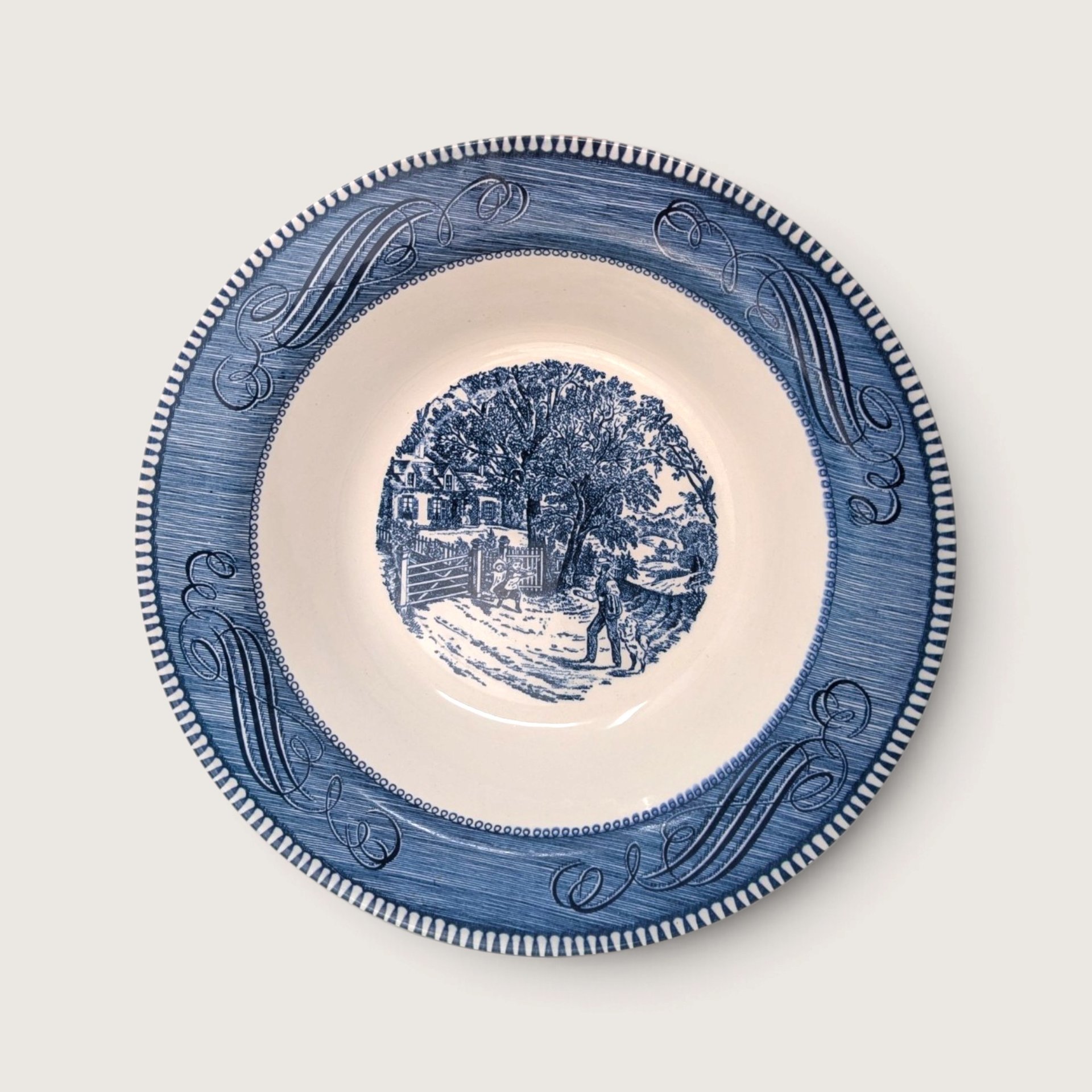 Vintage Royal China Currier and Ives blue transferware round vegetable serving bowl featuring the Home Sweet Home scene on a white backdrop.   