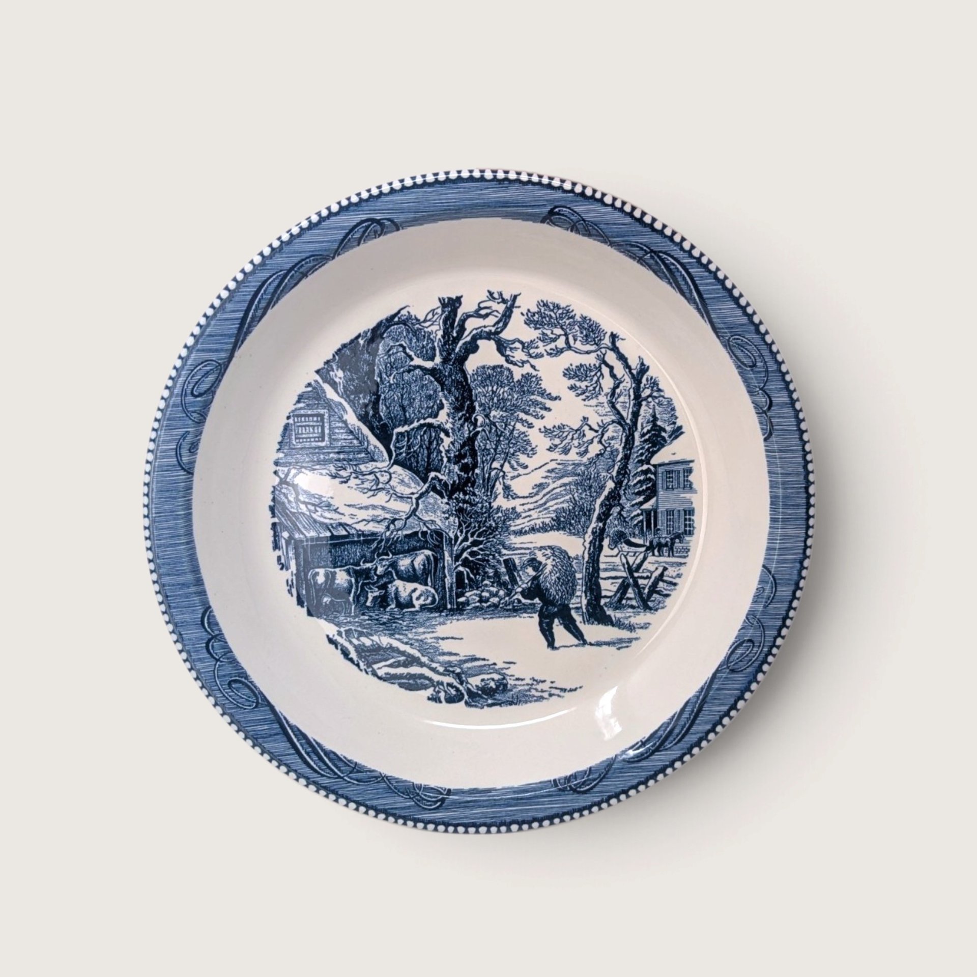 Vintage Royal China Currier and Ives blue transferware ceramic pie plate depicting A Snowy Morning winter farm scene on white backdrop.   
