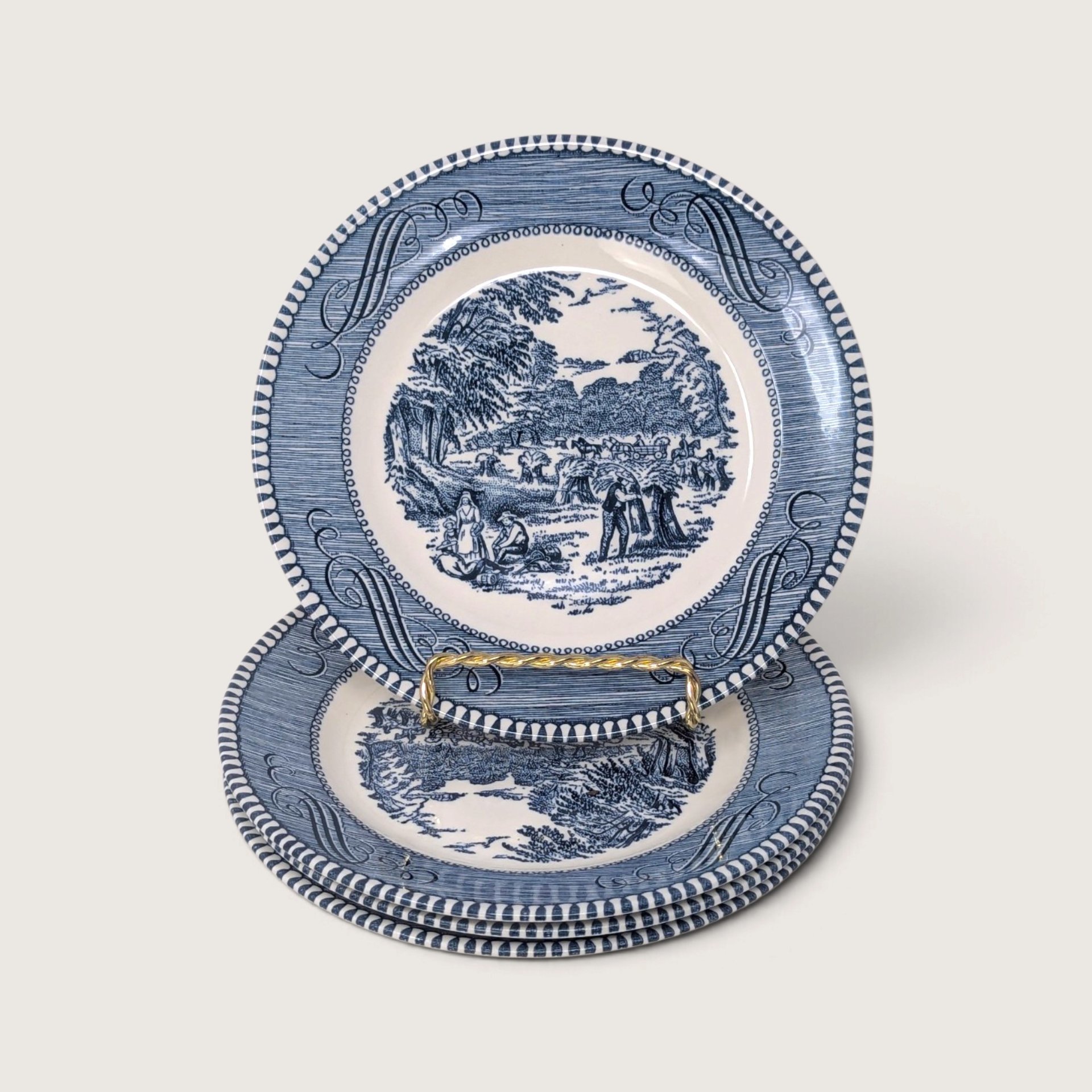 Vintage set of four Currier and Ives blue and white transferware bread and butter plates featuring the Harvest farming scene.   