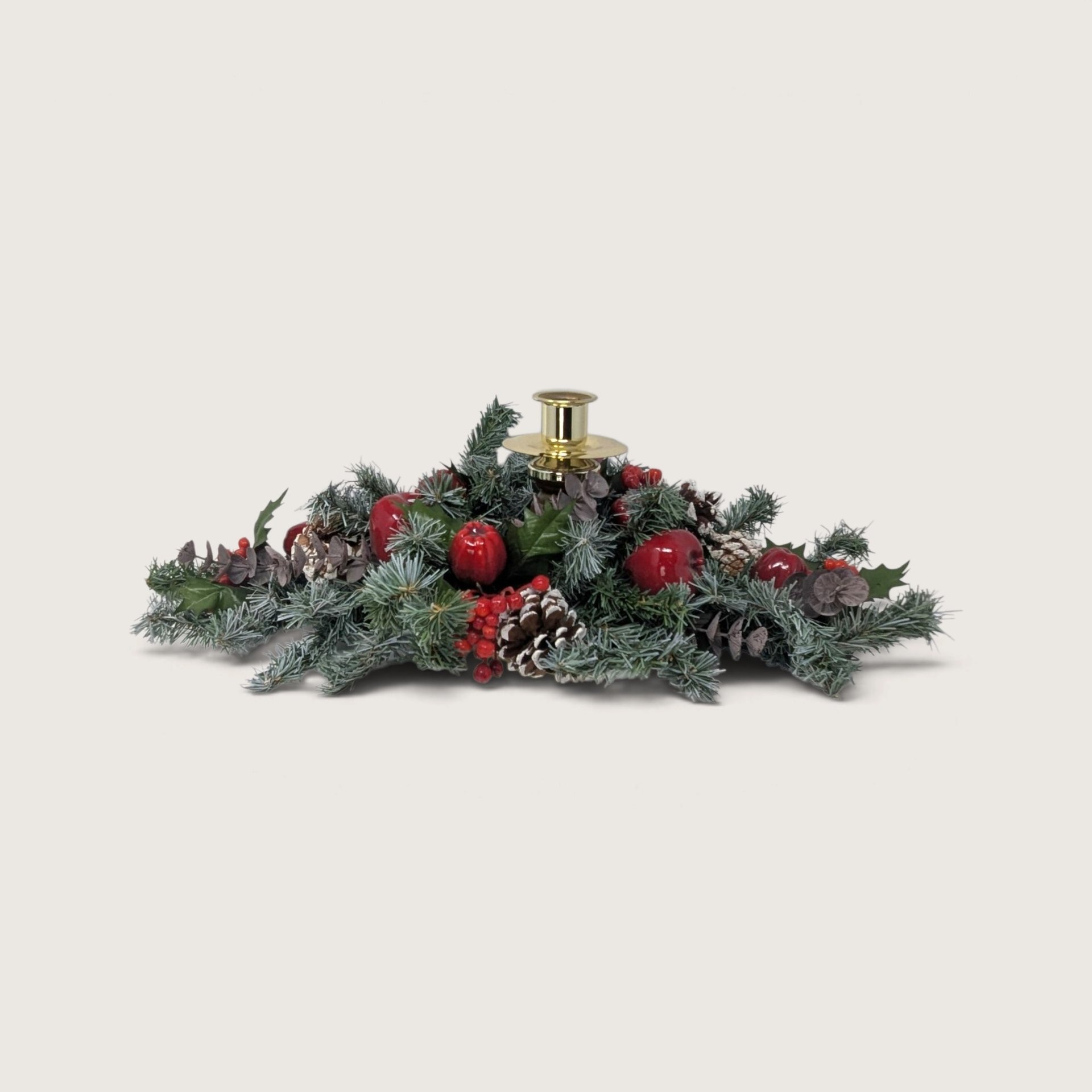 Vintage Home Interiors holiday candle centerpiece with brass taper cup surrounded by frosted pine boughs and red apples.   