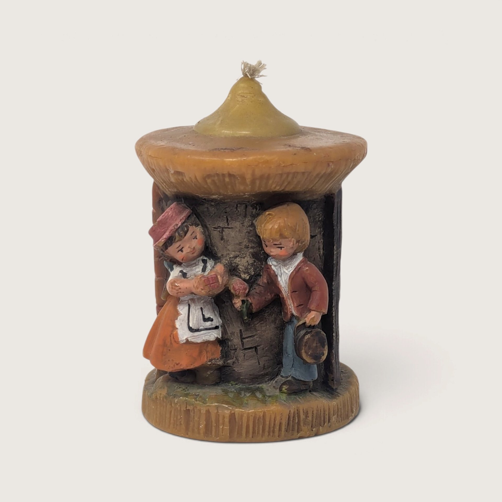 Vintage Günter Kerzen Walldürn hand-carved German wax candle depicting Bavarian boy and girl under a thatched roof.   