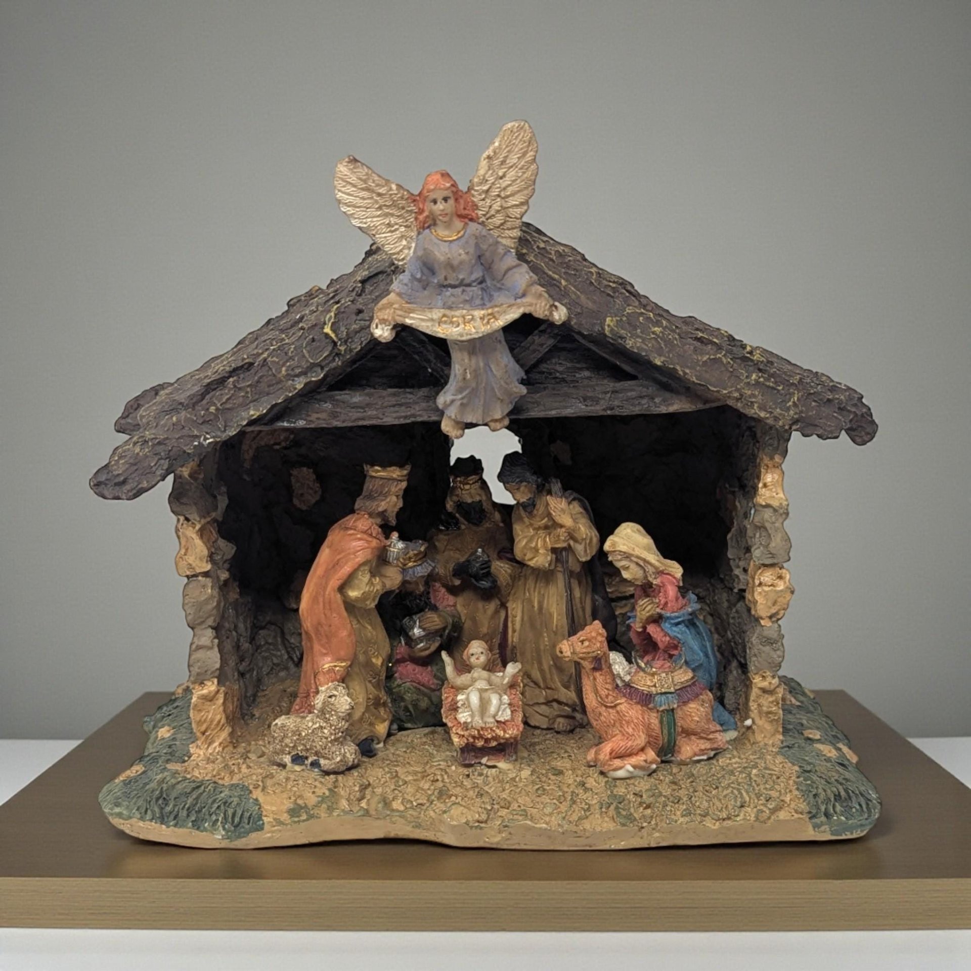 Vintage Resin Light Up Nativity Scene. Measures about 6.75" in height by 7.75" wide. Very good condition. Comes with a light cord.  Bring the true meaning of the season into your home with this beautiful, one-piece vintage nativity scene. Crafted from durable resin, this creche is detailed with a realistic texture that mimics hewn wood and stacked stone. The scene is bustling with figures, including Mary, Joseph, and Baby Jesus in the manger, surrounded by the Three Wise Men bearing gifts, and a resting cam