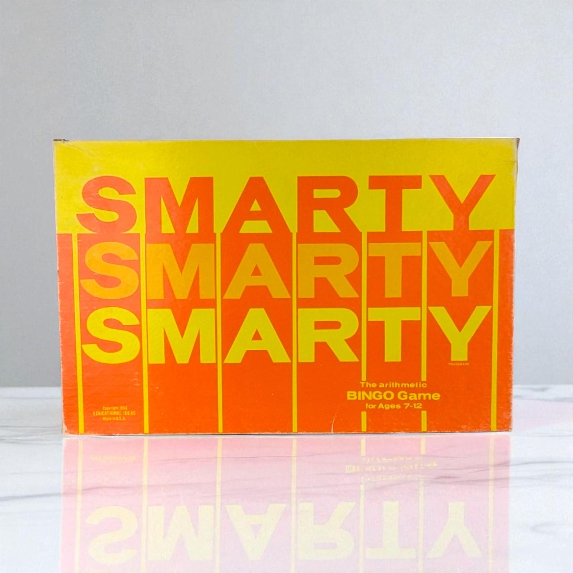 Rectangular vintage game box with a vibrant yellow and orange color scheme. The word SMARTY is repeated three times in a bold, stacked sans-serif font. The texture appears to be matte cardboard with minor edge wear.